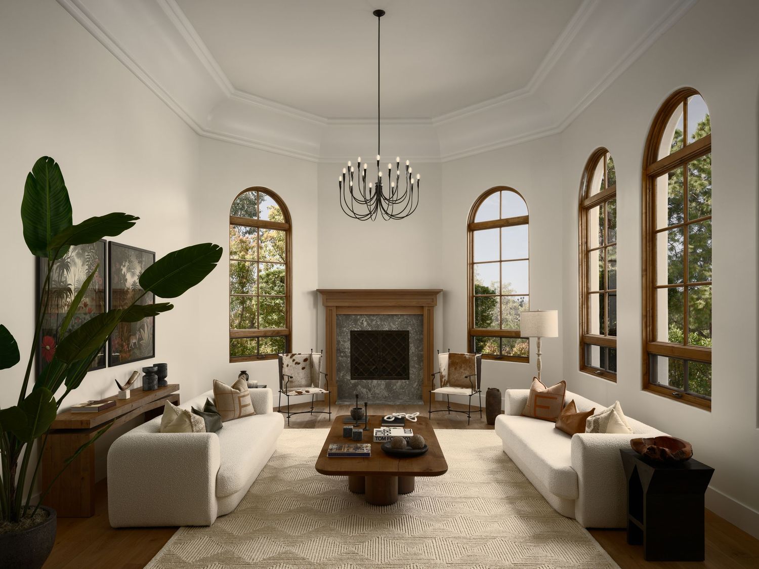 Rancho Santa Fe luxury home living room photographed for a builder, featuring arched windows, soft furnishings, and natural light.