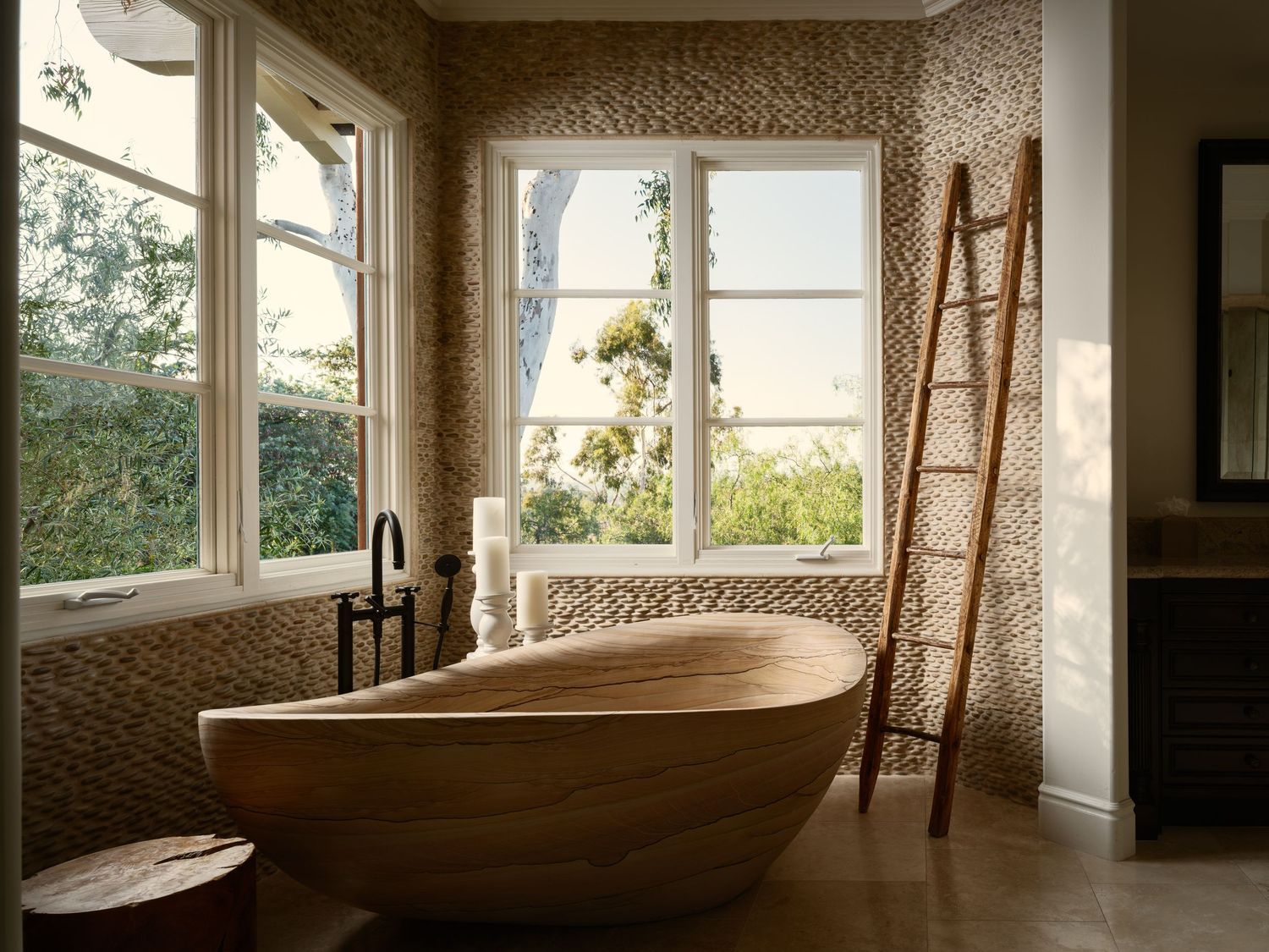 High-end real estate and interior design photography of the luxury bathroom at Rancho Valencia in Rancho Santa Fe featuring sculptural wood