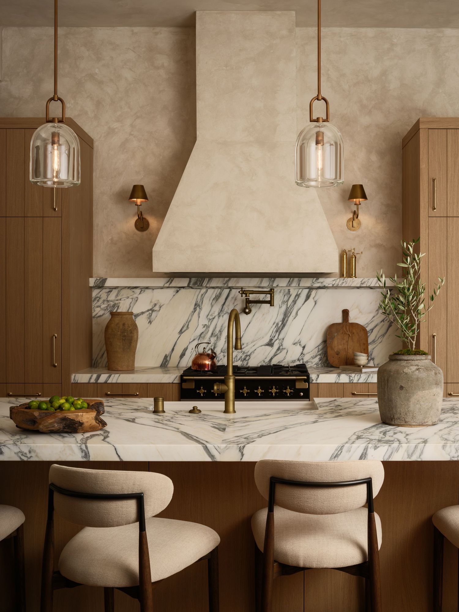 San Diego kitchen interior with marble countertops, limewash walls, wood cabinetry, and pendant lighting captured in natural-light photo