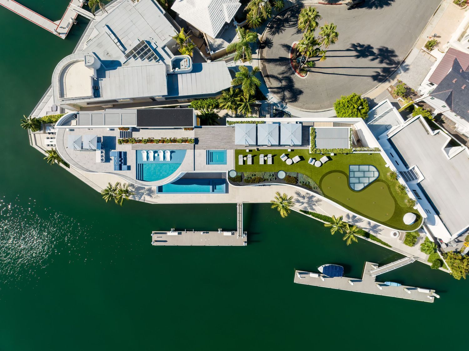 Aerial bird’s-eye view of 3 The Point waterfront home with pool terrace, lawn, and private dock, photographed in Coronado, San Diego.
