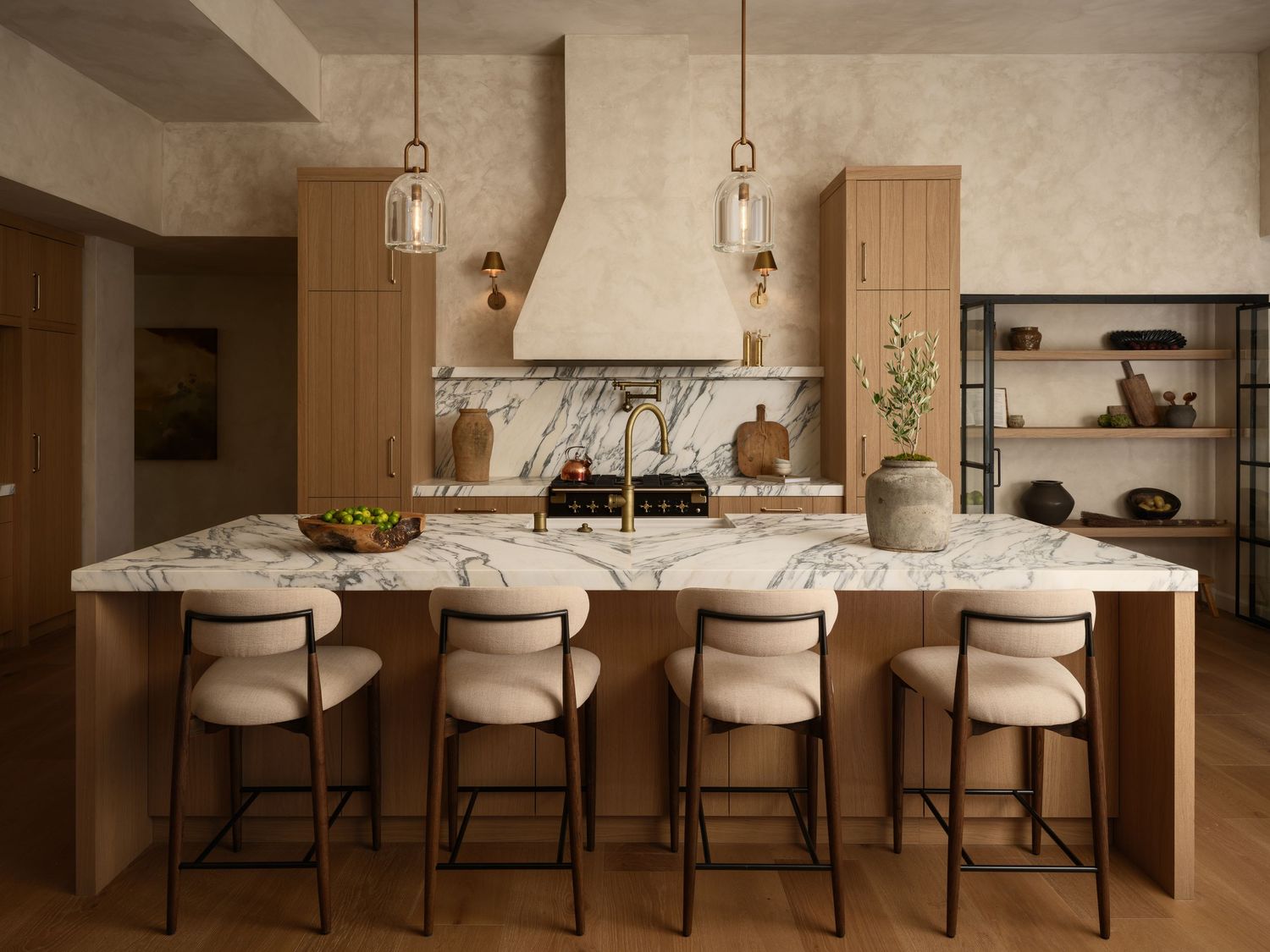 La Jolla luxury kitchen interior photography featuring limewash walls, marble island, natural wood cabinetry, and modern designer lighting
