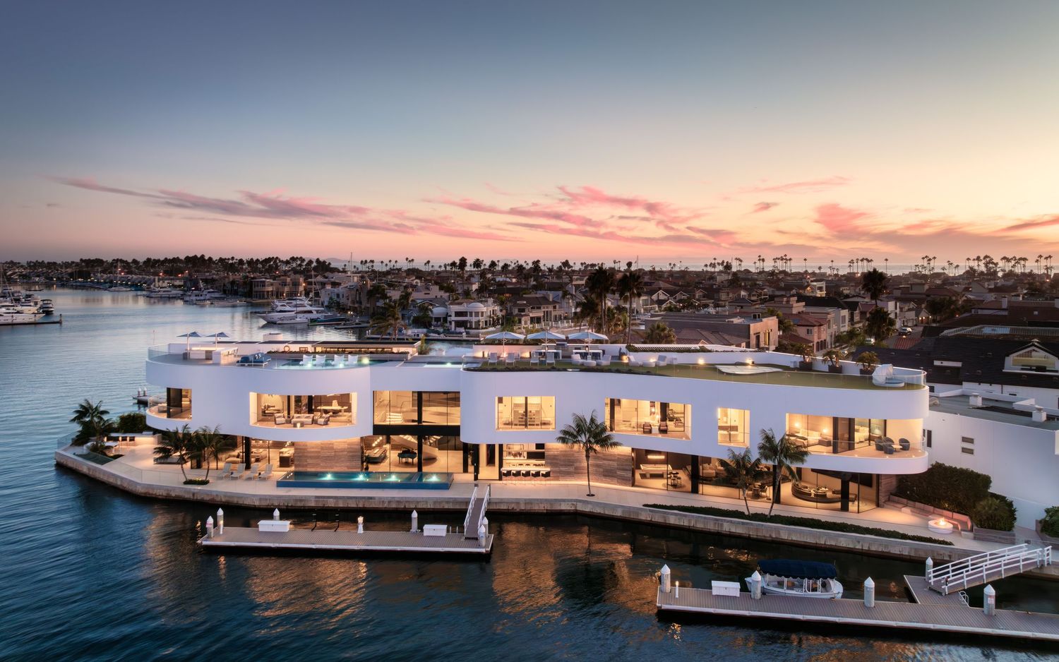Aerial view of Coronado 3 The Point showcasing curved luxury waterfront architecture and panoramic bay views at sunset