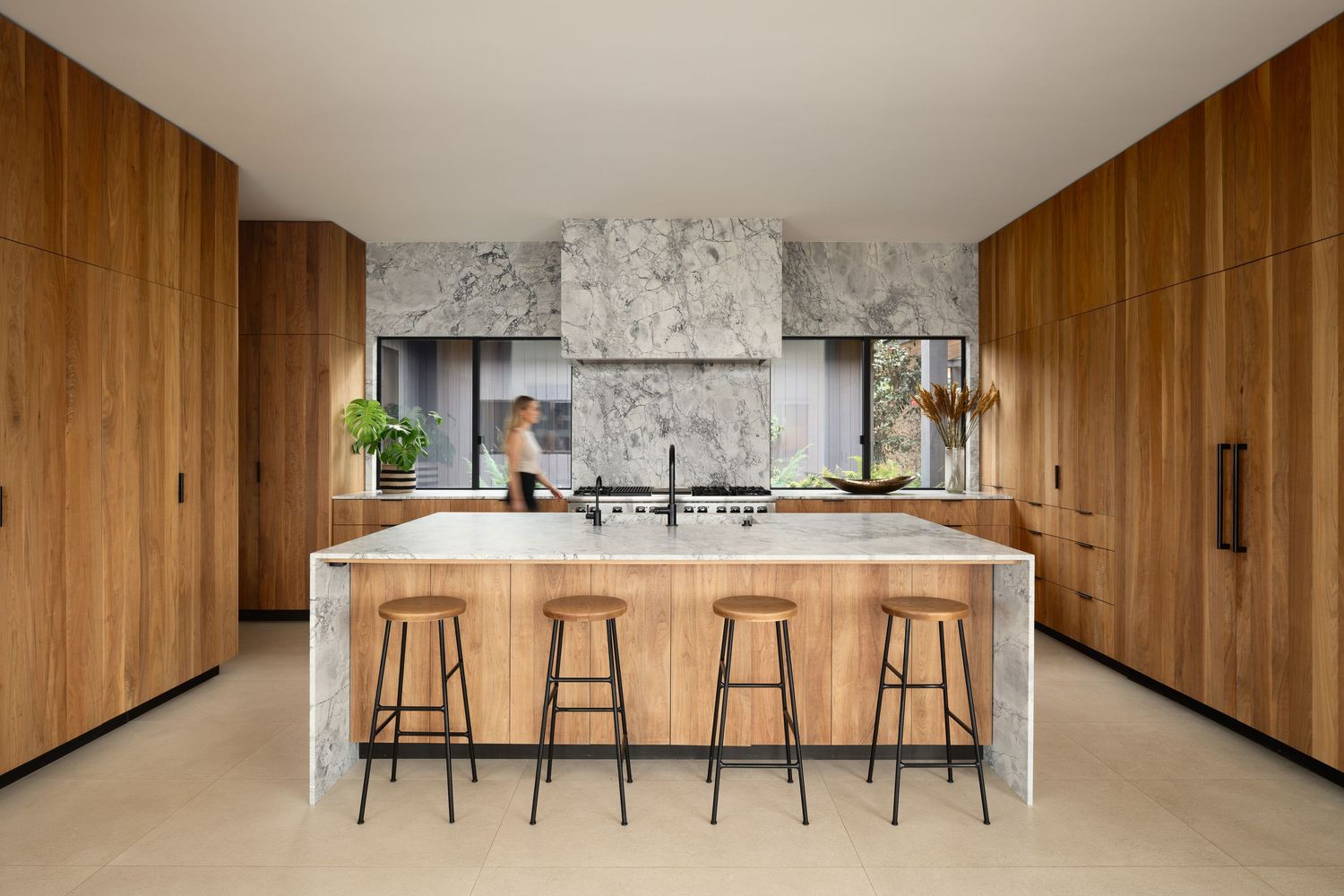 Modern kitchen at 7404 Hillside Drive with marble island, integrated wood cabinetry, and restrained contemporary detailing.
