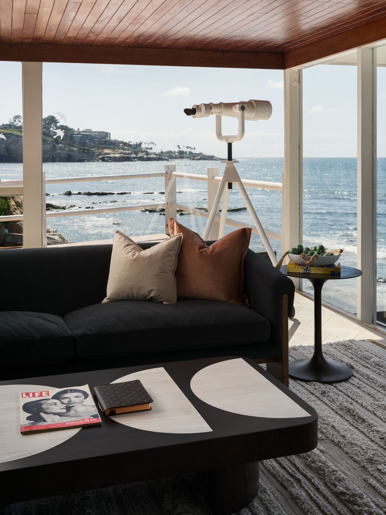 Oceanfront sitting area at 1890 Spindrift Drive featuring floor-to-ceiling glass, modern furnishings, and uninterrupted coastline views.