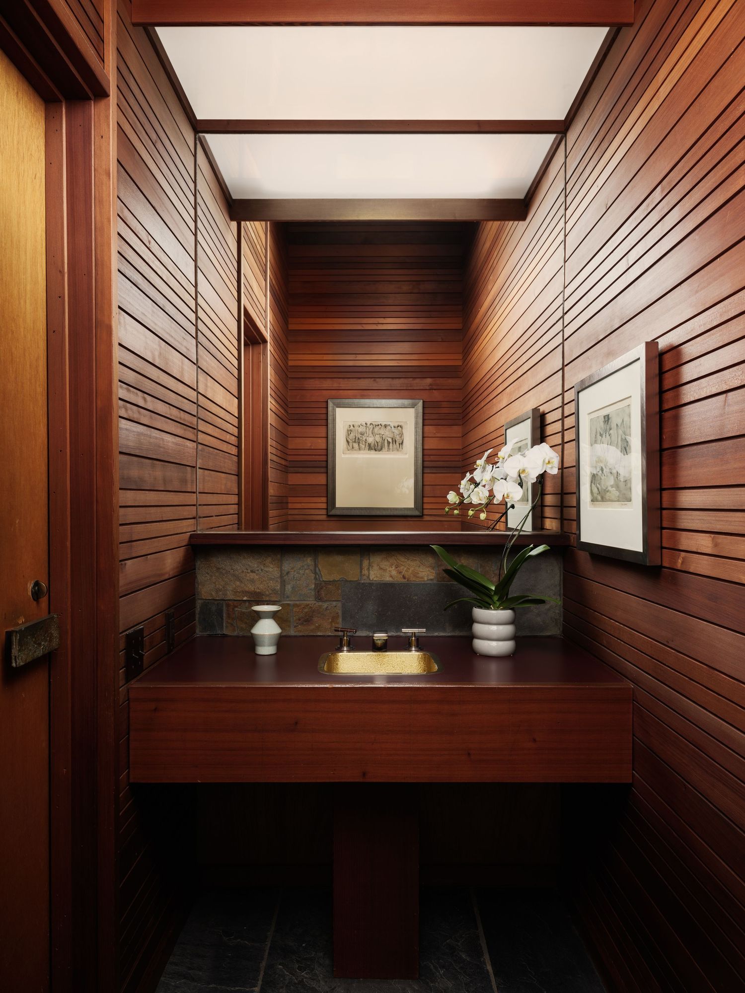 Powder room at 7226 Romero with warm wood walls and modern fixtures, interior design photography san diego capturing midcentury detail.