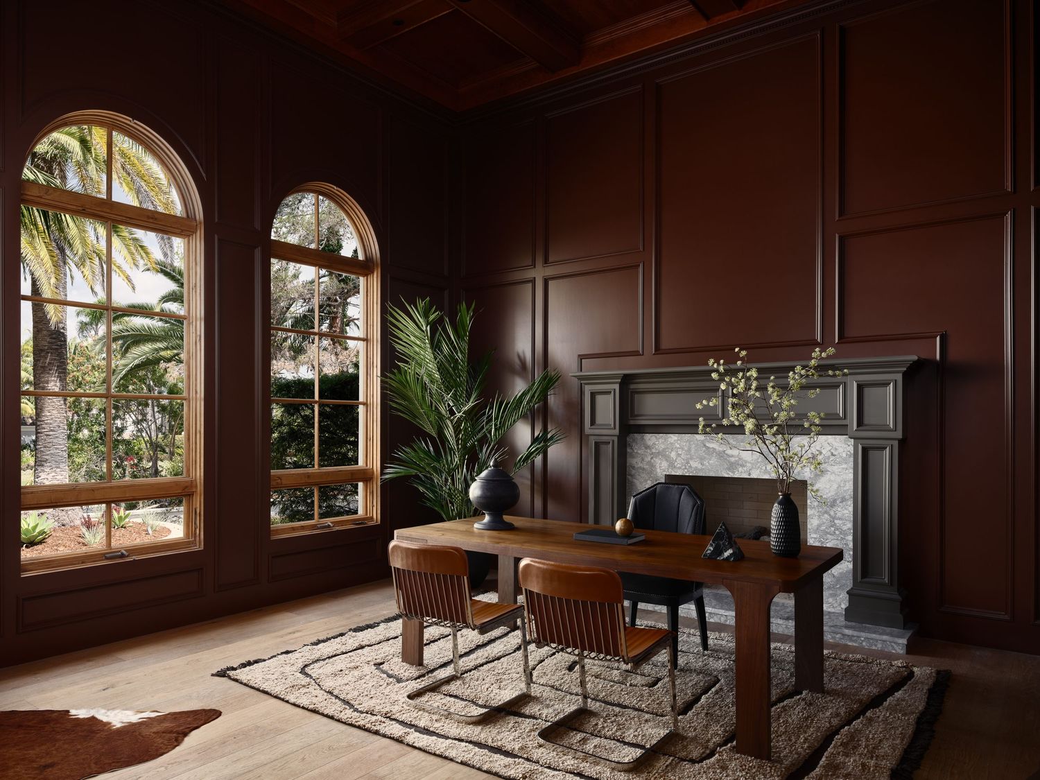 Luxury home office photographed in Rancho Santa Fe flip, featuring rich wood paneling, arched windows, and high-end detailing.
