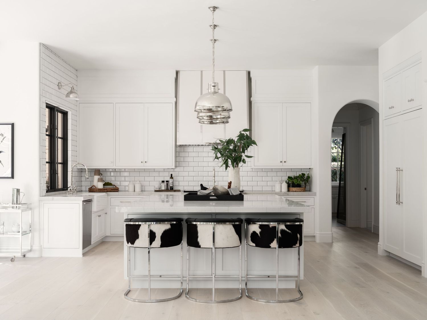 Rancho Santa Fe luxury kitchen with white cabinetry, marble island, and modern pendants—interior design photography by Luca Prodi