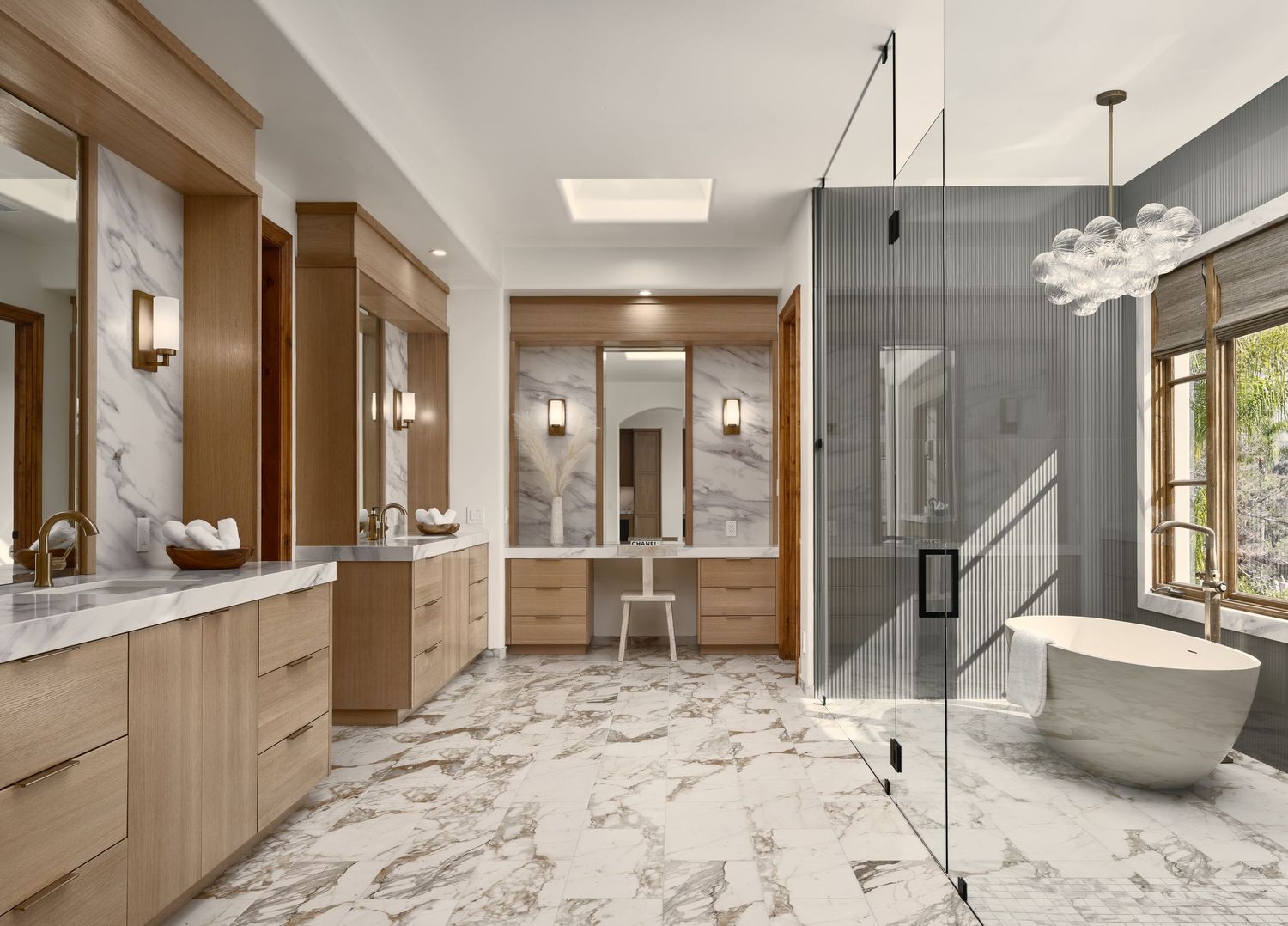 Spacious luxury bathroom photographed in Rancho Santa Fe flip for a high-end builder, featuring double vanities and glass shower.