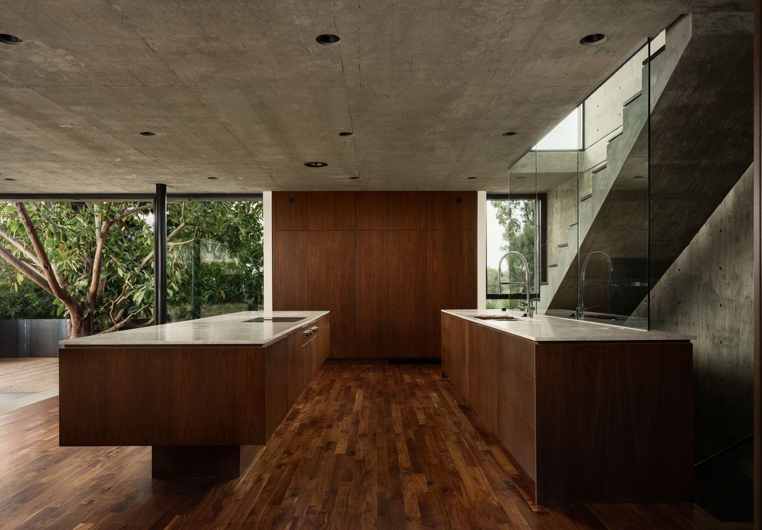 Arista Residence kitchen interior by Matthew Segal, custom wood cabinetry, concrete ceiling, and open-plan modern architecture.
