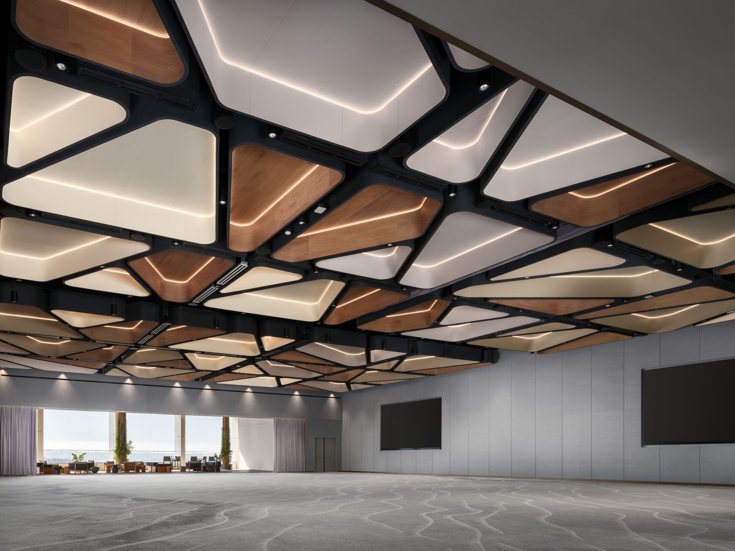 Architectural photo of an Acoufelt acoustic ceiling installation in a large commercial event space with modern panel design and soft ambient