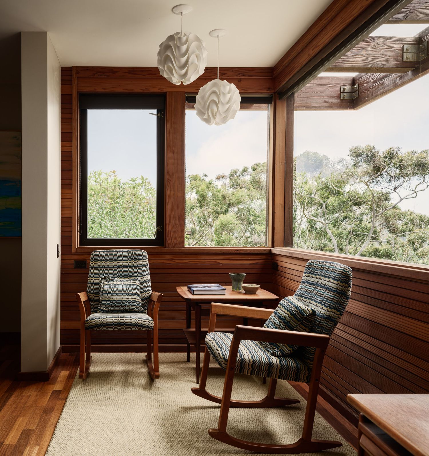 Sitting nook at 7226 Romero with wood accents and large windows to eucalyptus views, real estate photography san diego.