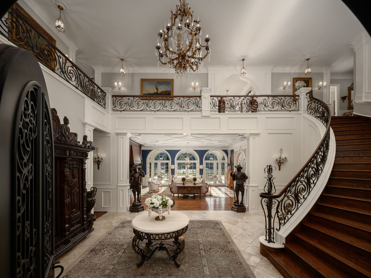 Architectural photo of a grand double staircase and marble foyer at Fielding House, showcasing luxury detailing and refined interior design.