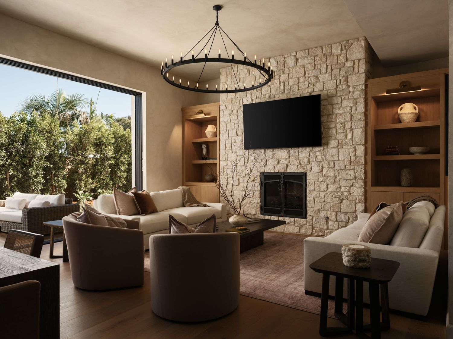 La Jolla living room with stone fireplace, custom built-ins, and indoor-outdoor design captured in architectural photography