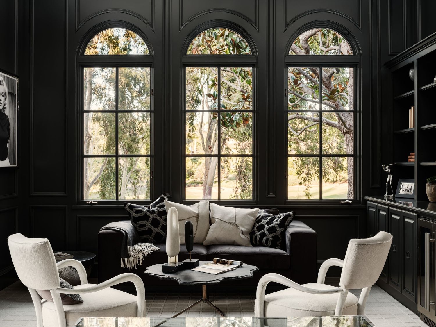 Rancho Santa Fe luxury home library with arched windows, dark millwork, and curated seating—interior photography by Luca Prodi