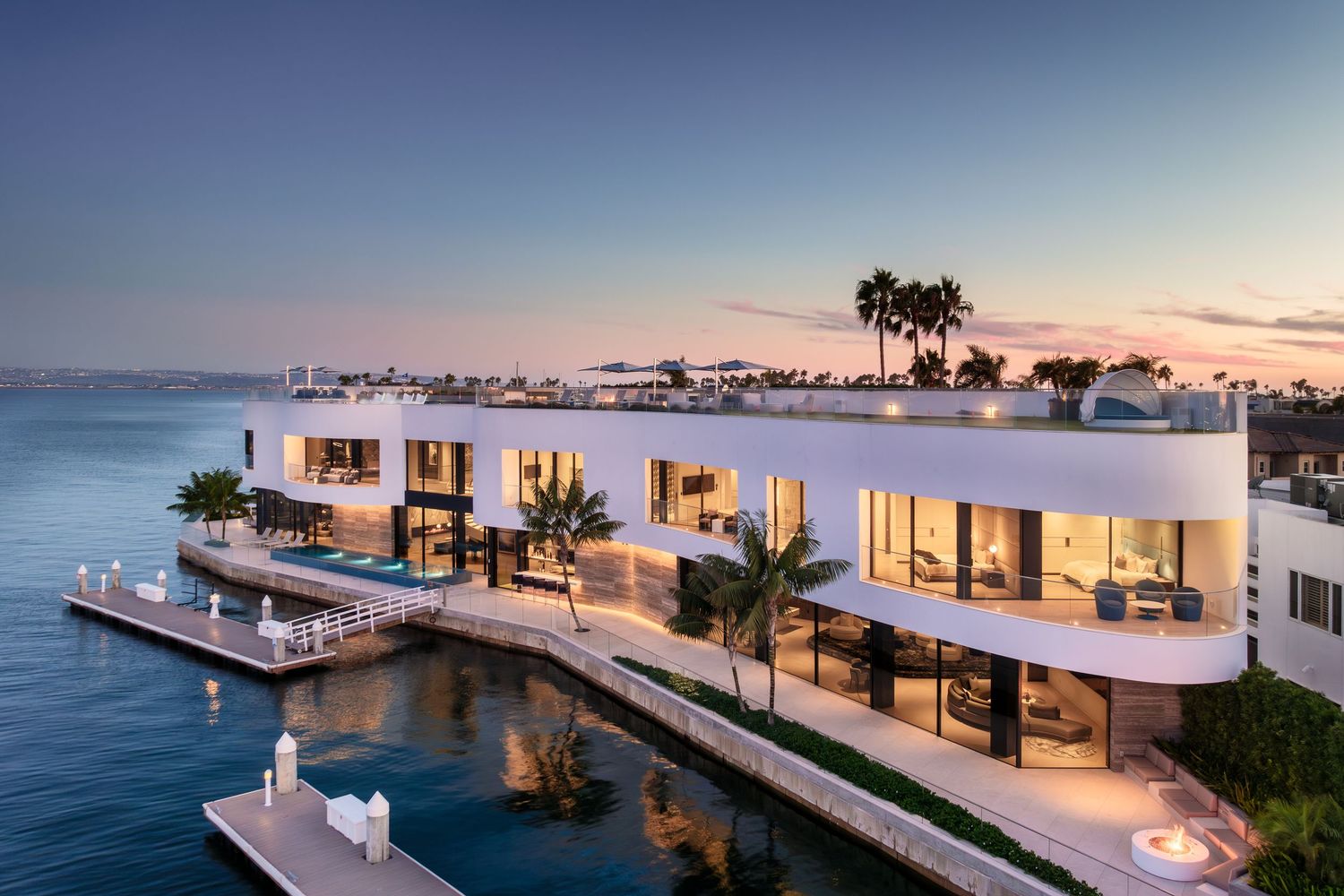 Coronado 3 The Point luxury waterfront residence at dusk with curved modern architecture and bayfront setting