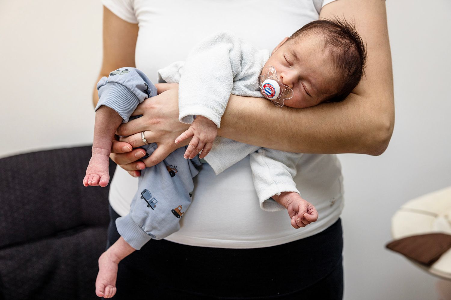 Sequence of photos showing a baby's feet being gently massaged during an infant massage session.