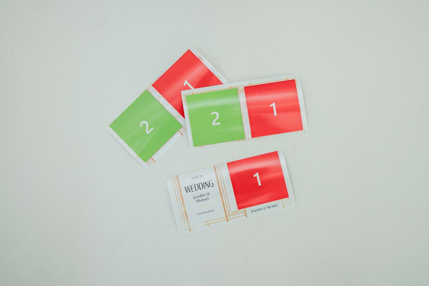 Green and red numbered cards with a Wedding booklet arranged on a light gray background.