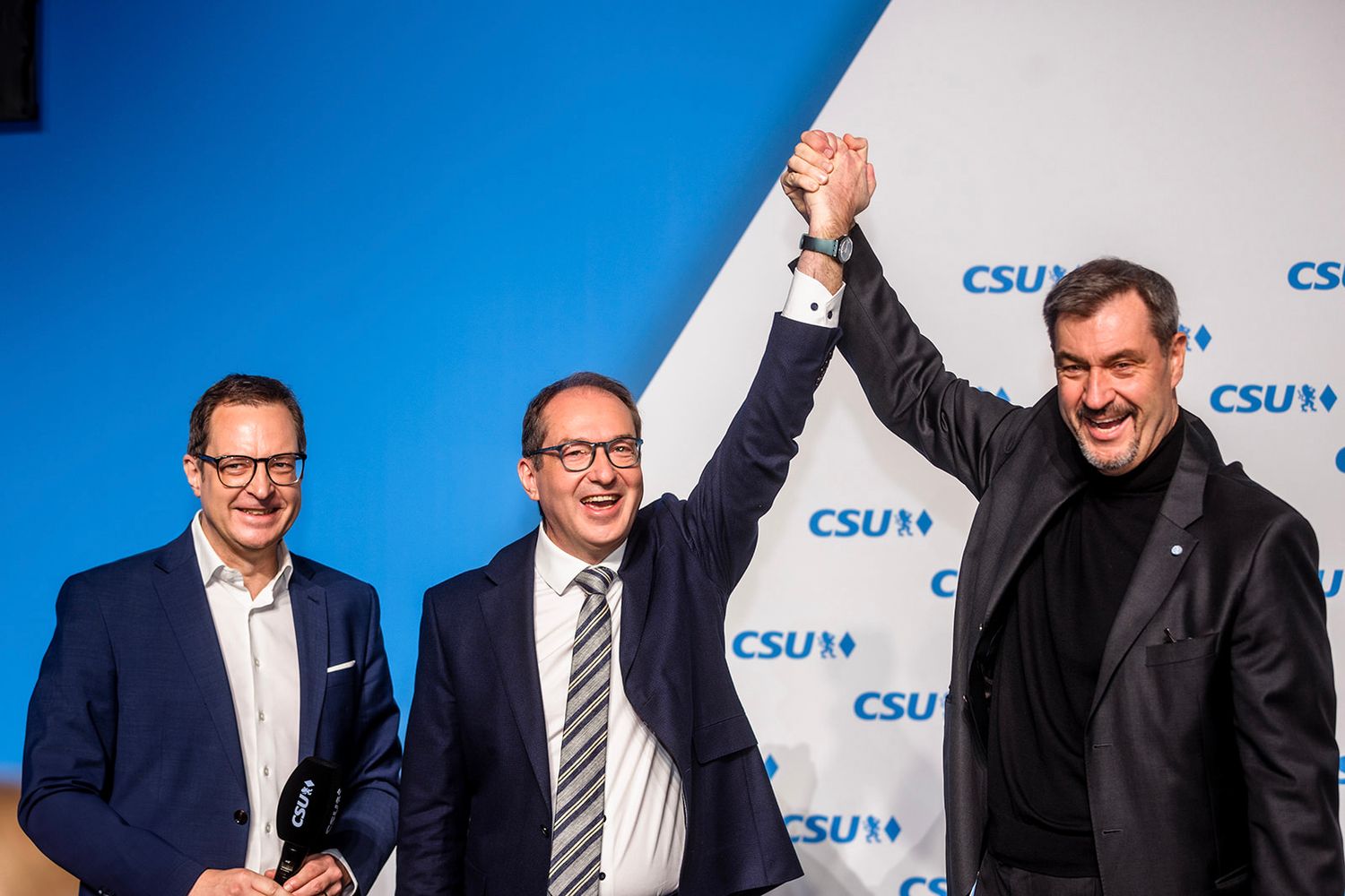 Professional event photos with blue CSU party backdrop and stage lighting.