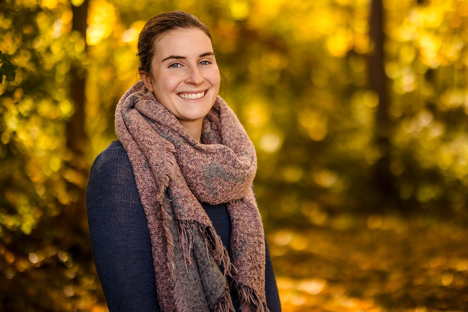 Fall portrait session featuring warm autumn colors and cozy knit accessories.
