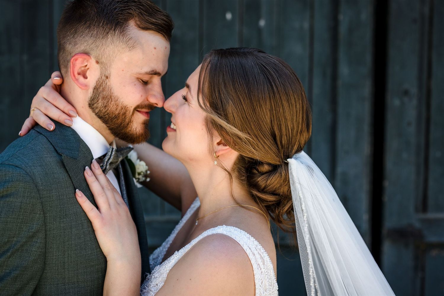 A romantic wedding couple shares intimate kisses in a series of black and white photographs.