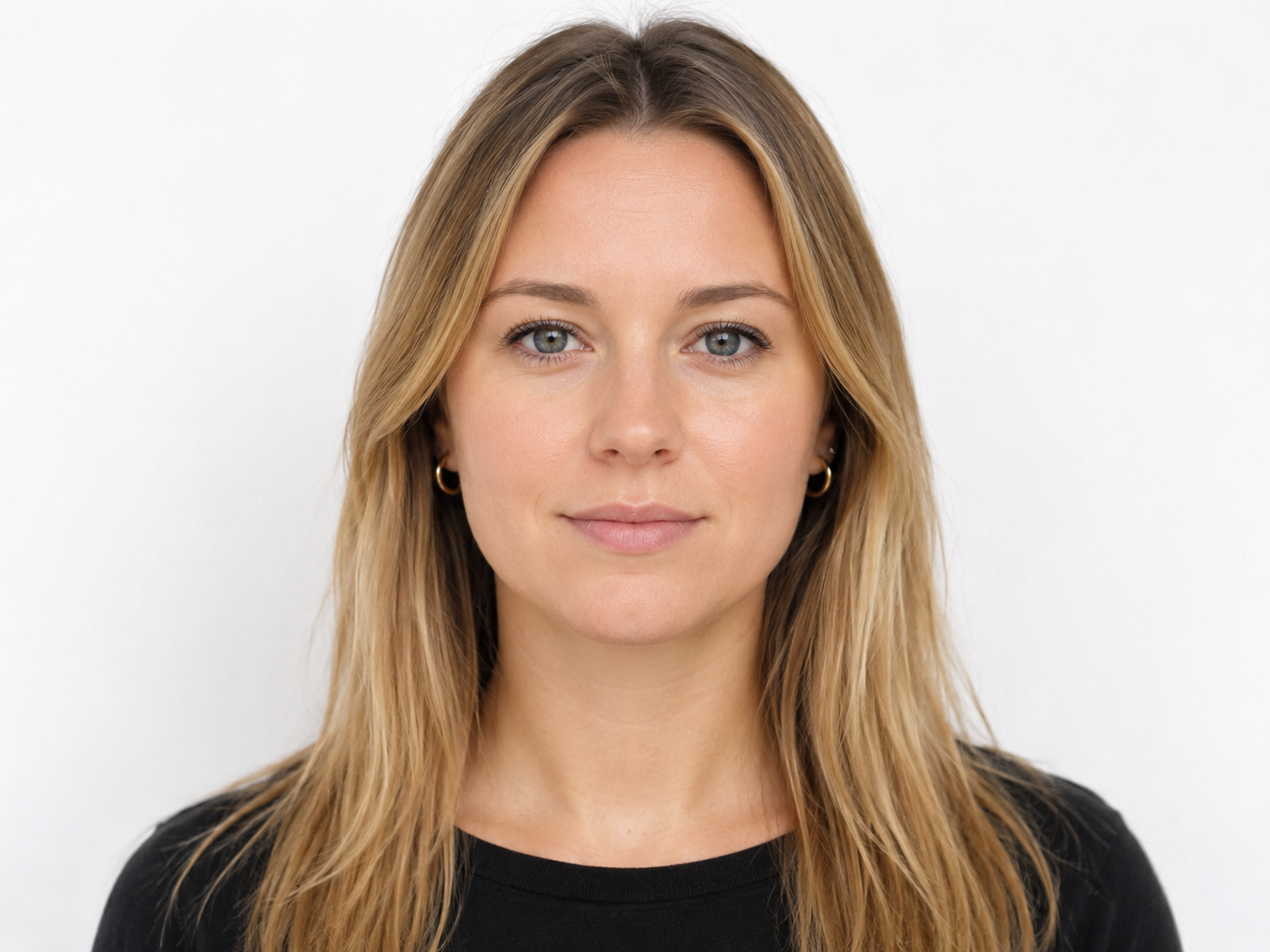 Professional headshot of a young woman with long blonde hair wearing a black top against a white background.