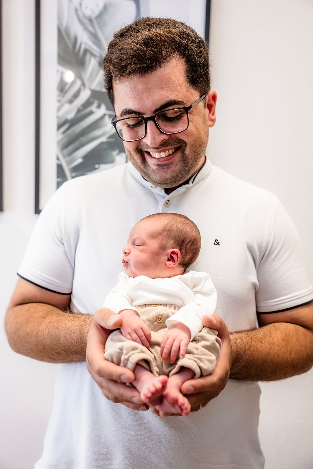 A tender moment captured in a series of photos showing a parent cradling and bonding with their newborn baby.