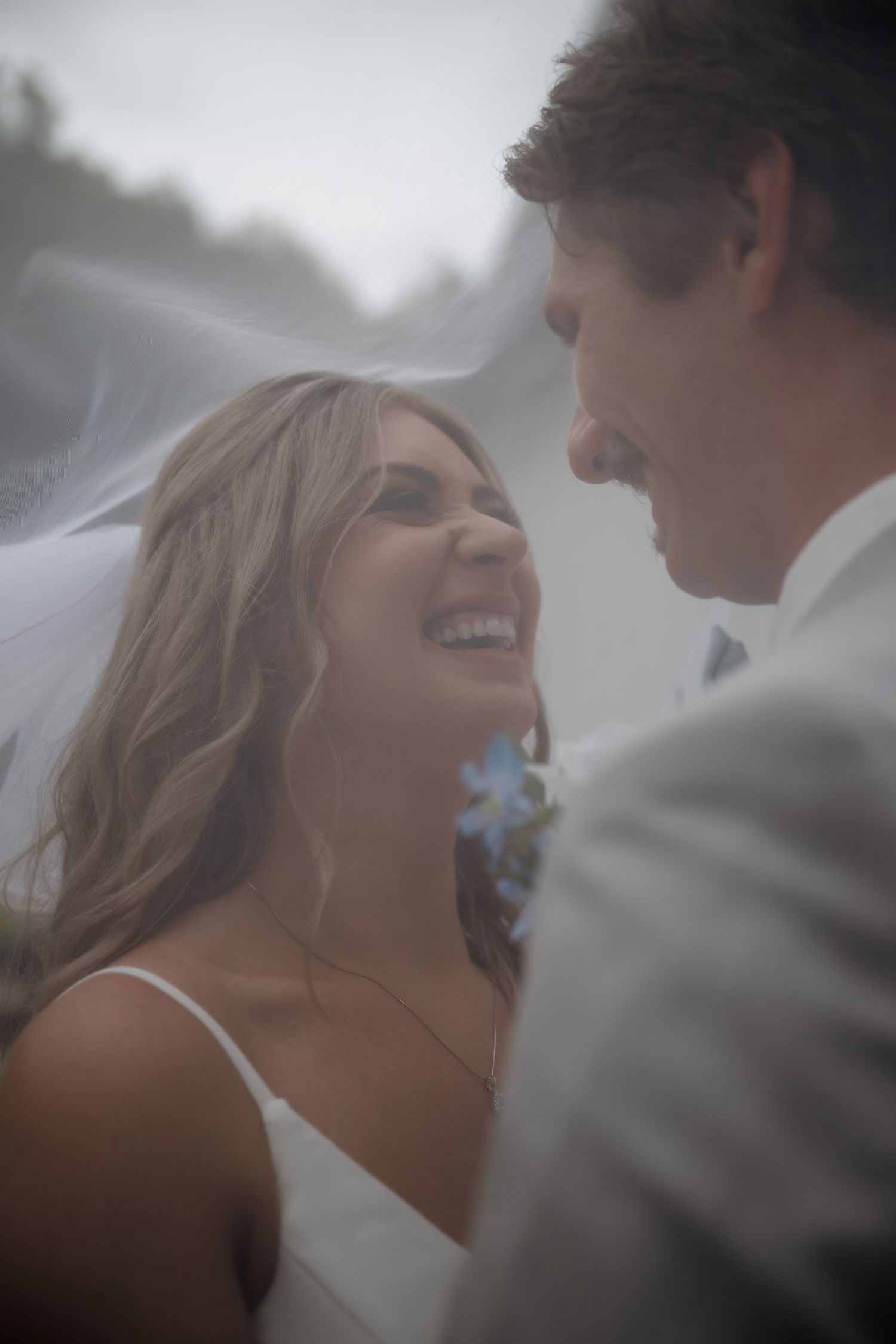 An intimate wedding portrait captured in dreamy, misty lighting.