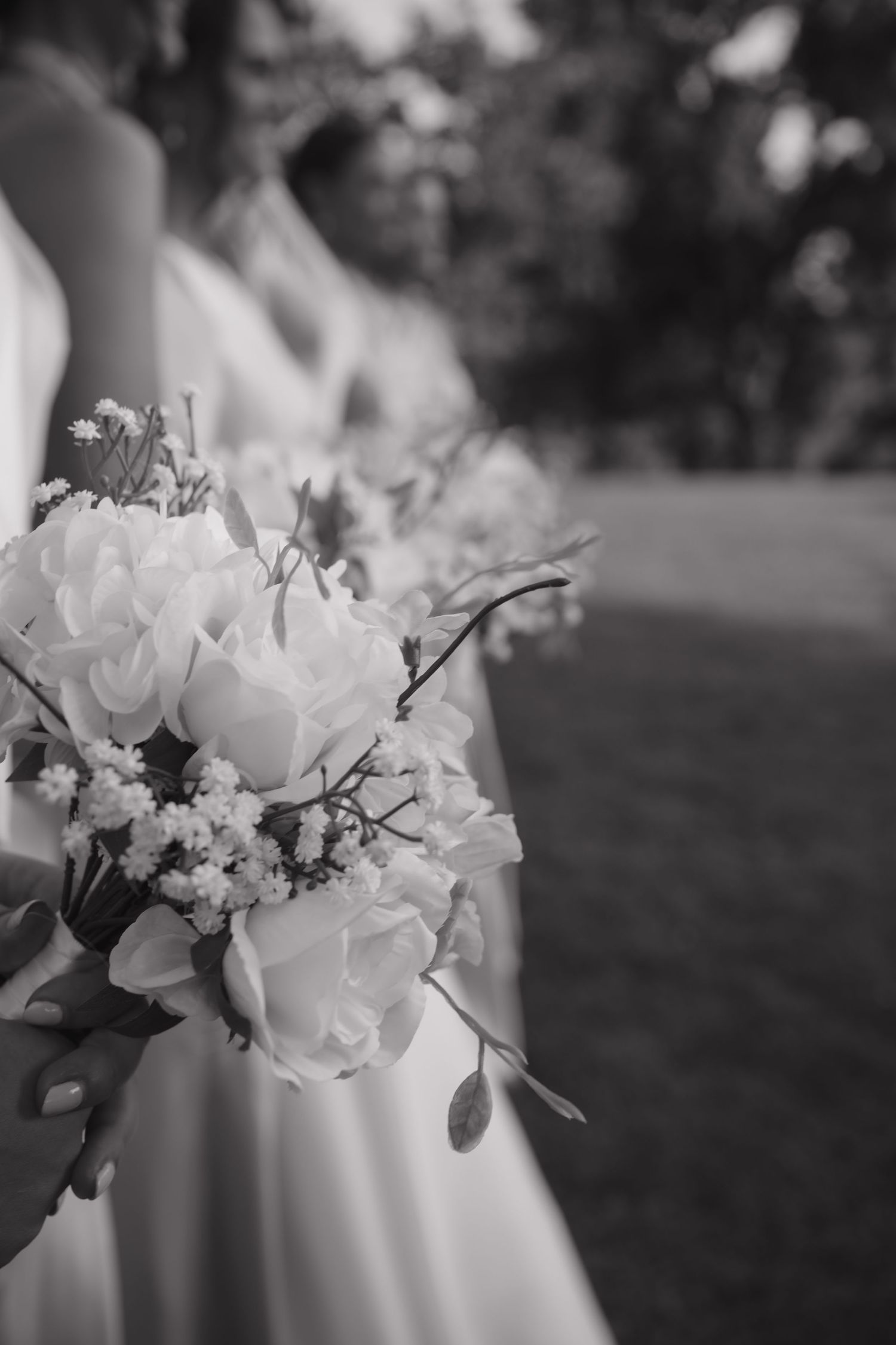 Elegant white floral wedding bouquet in black and white photography.