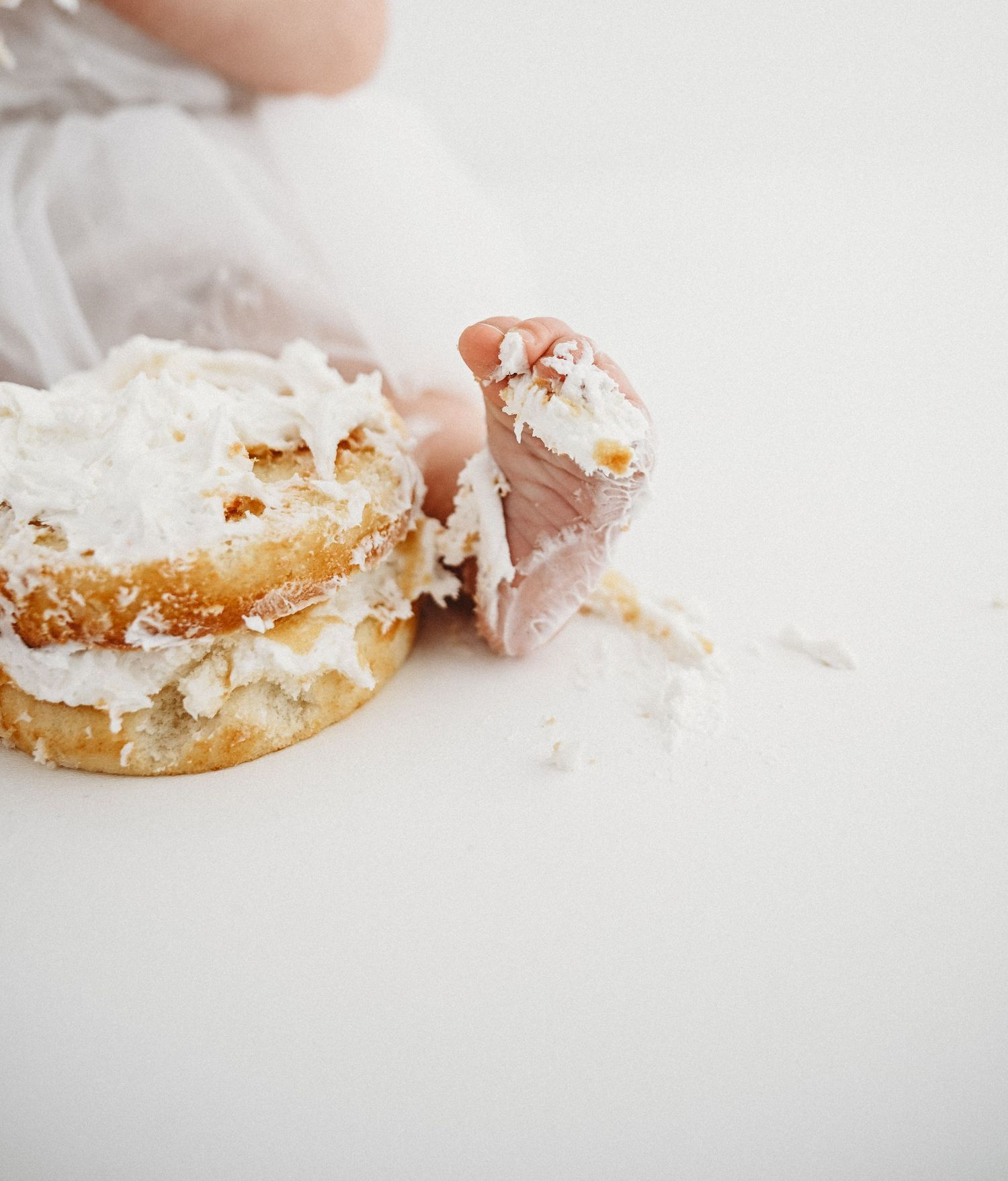 A sequence of four images showing a partially eaten sandwich with white filling on a light background.