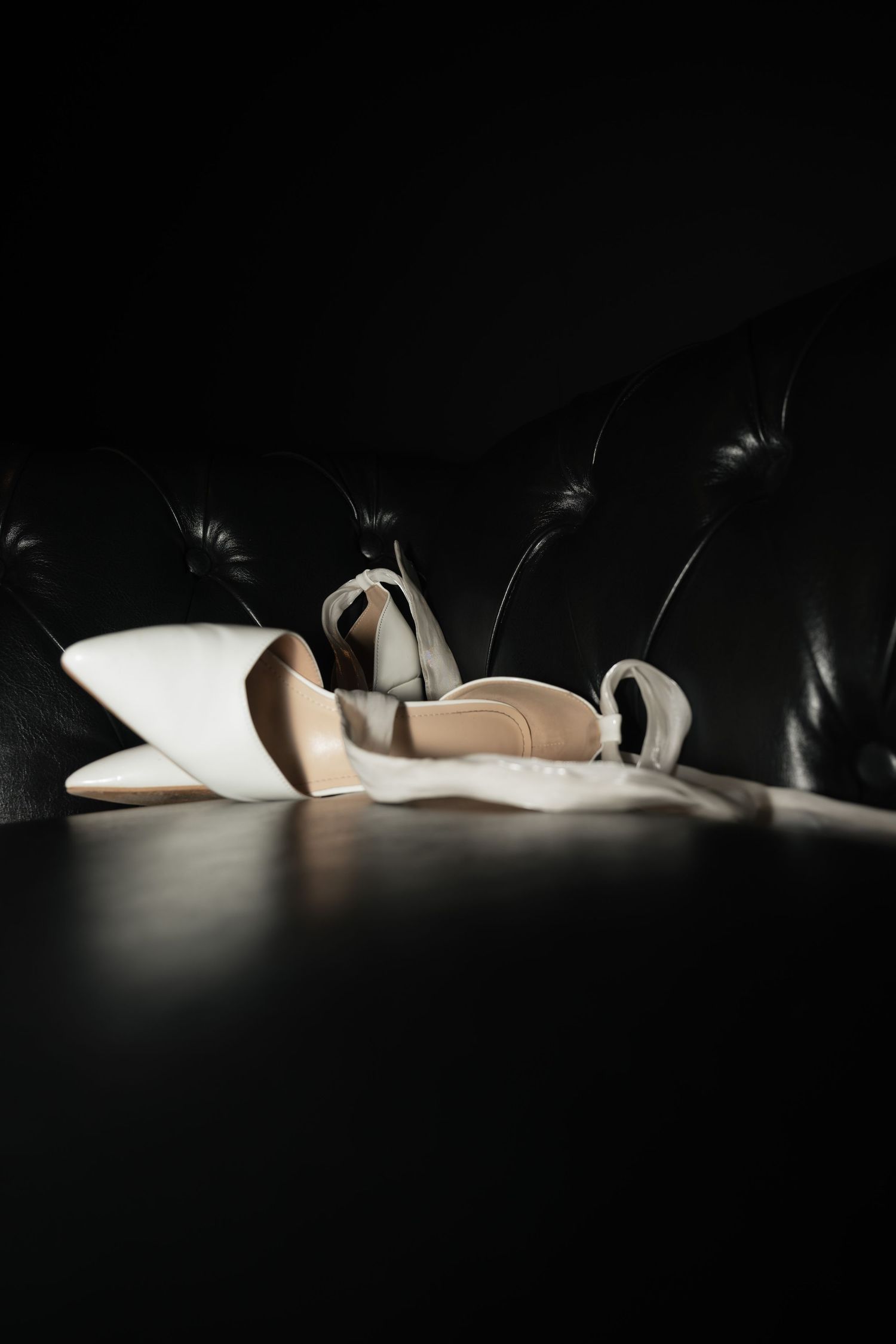 Dramatic low-key lighting on white objects creating long shadows.