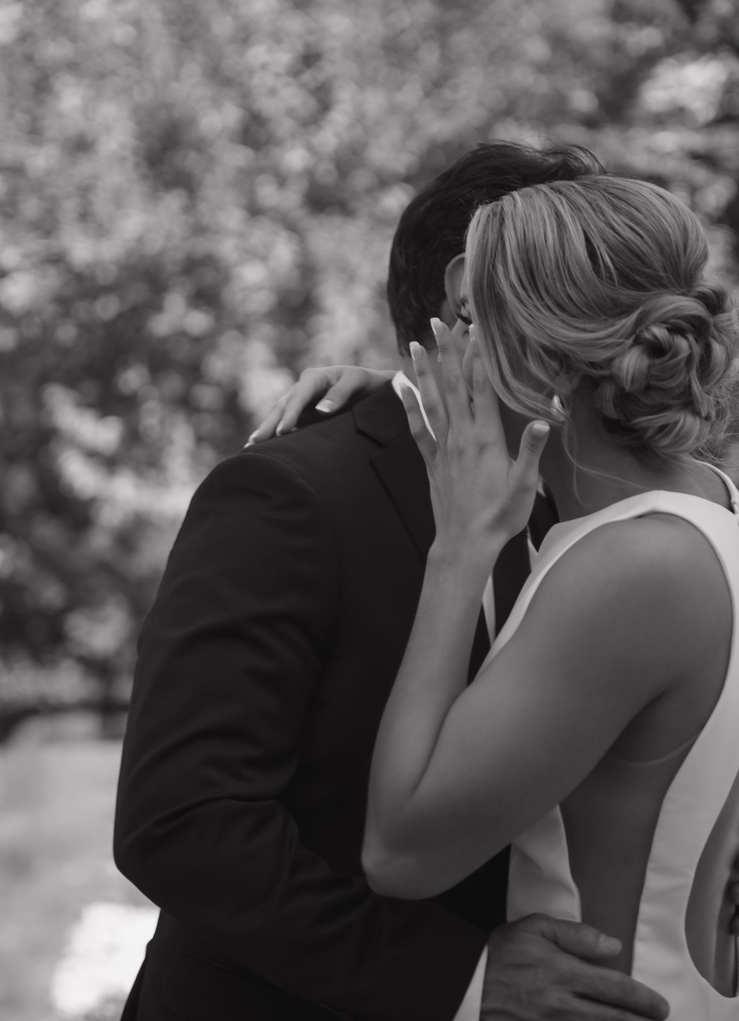 Black and white emotional moment captured during outdoor wedding ceremony.