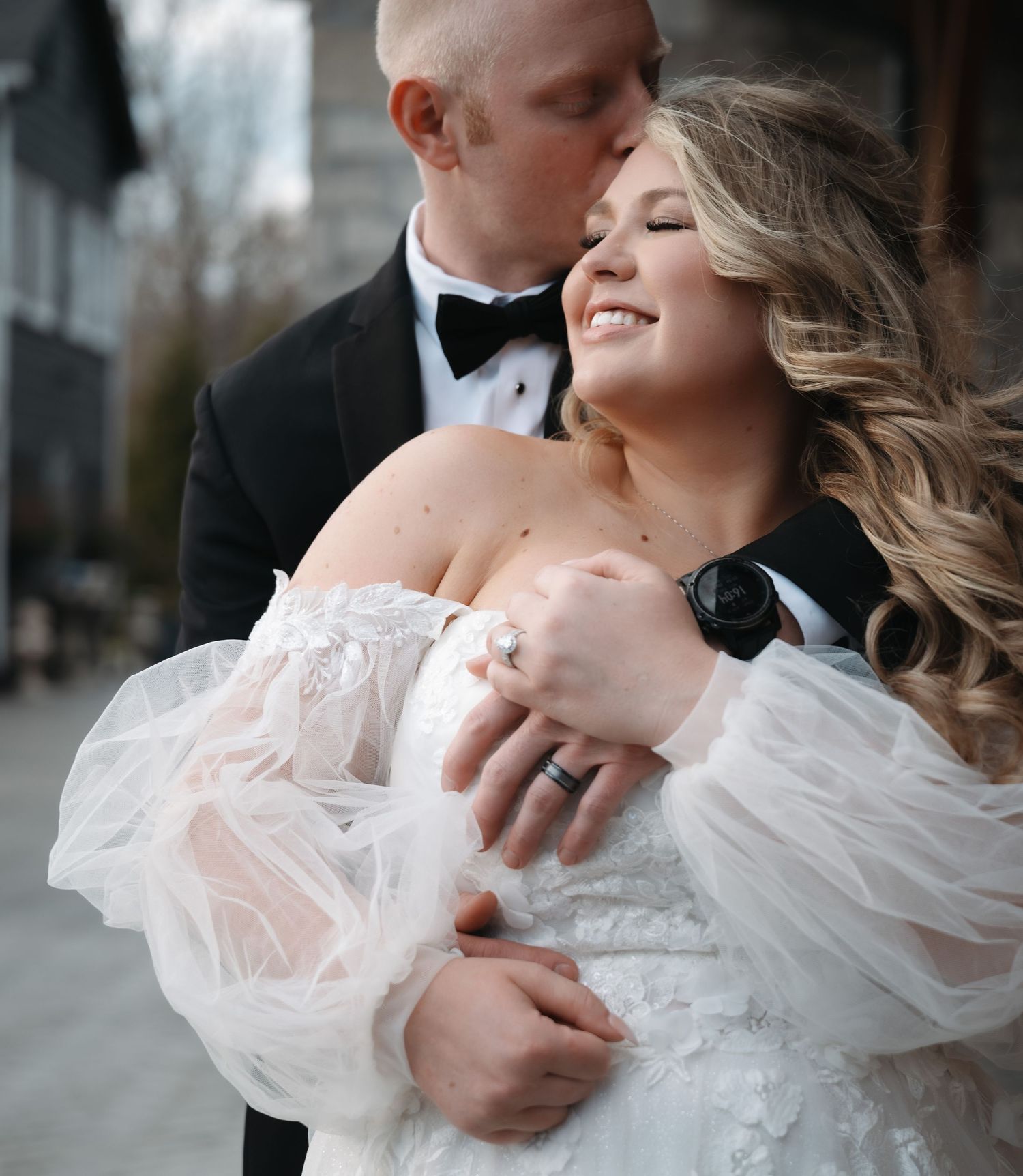 A tender moment between newlyweds captured in an intimate black and white portrait.