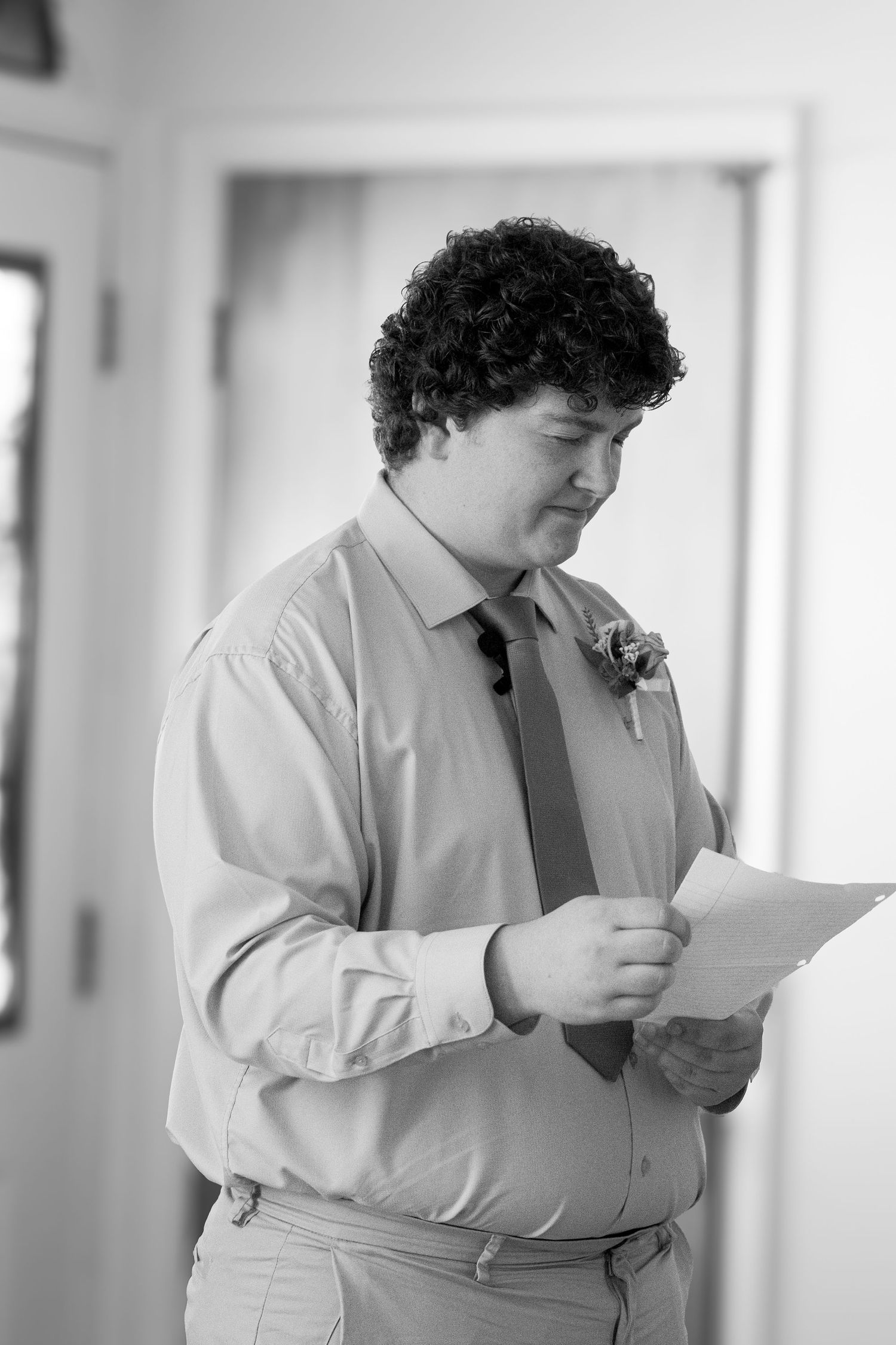 Man in white dress shirt getting emotional reading vows.