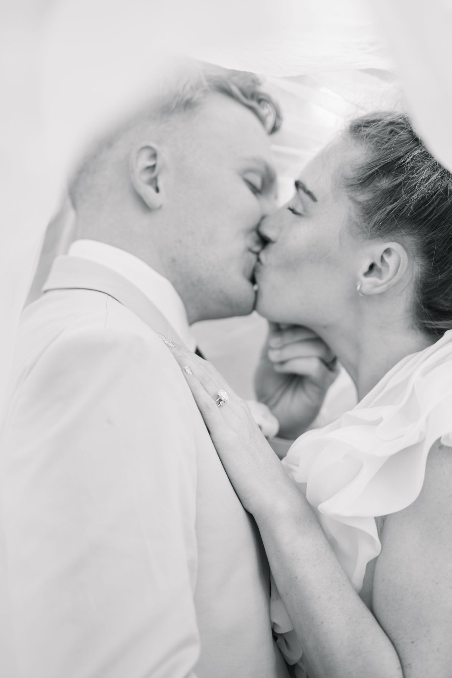A romantic black and white photo series showing an intimate couple sharing tender kisses and embraces.