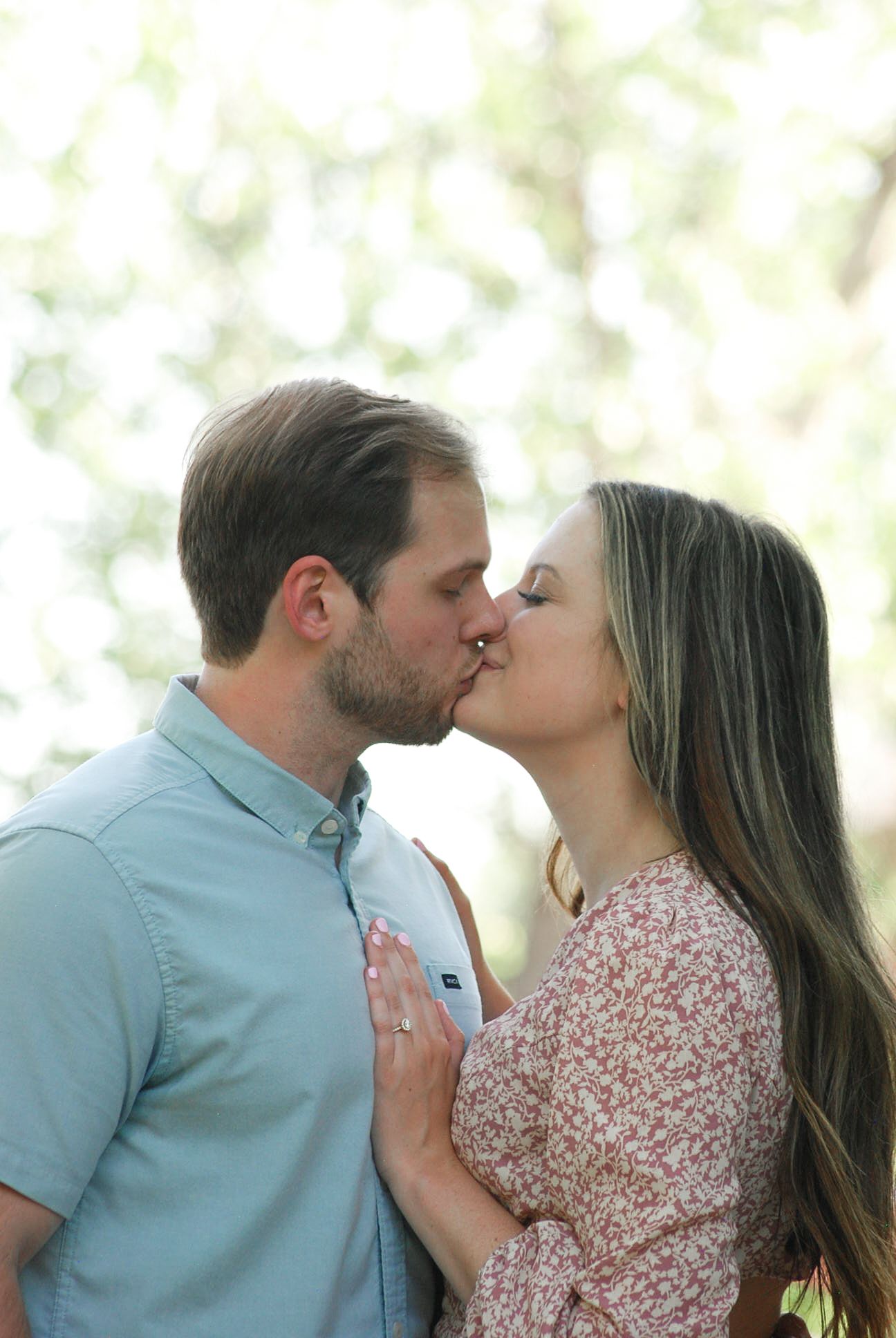 Tender sequence of a couple sharing intimate kisses in natural outdoor lighting.