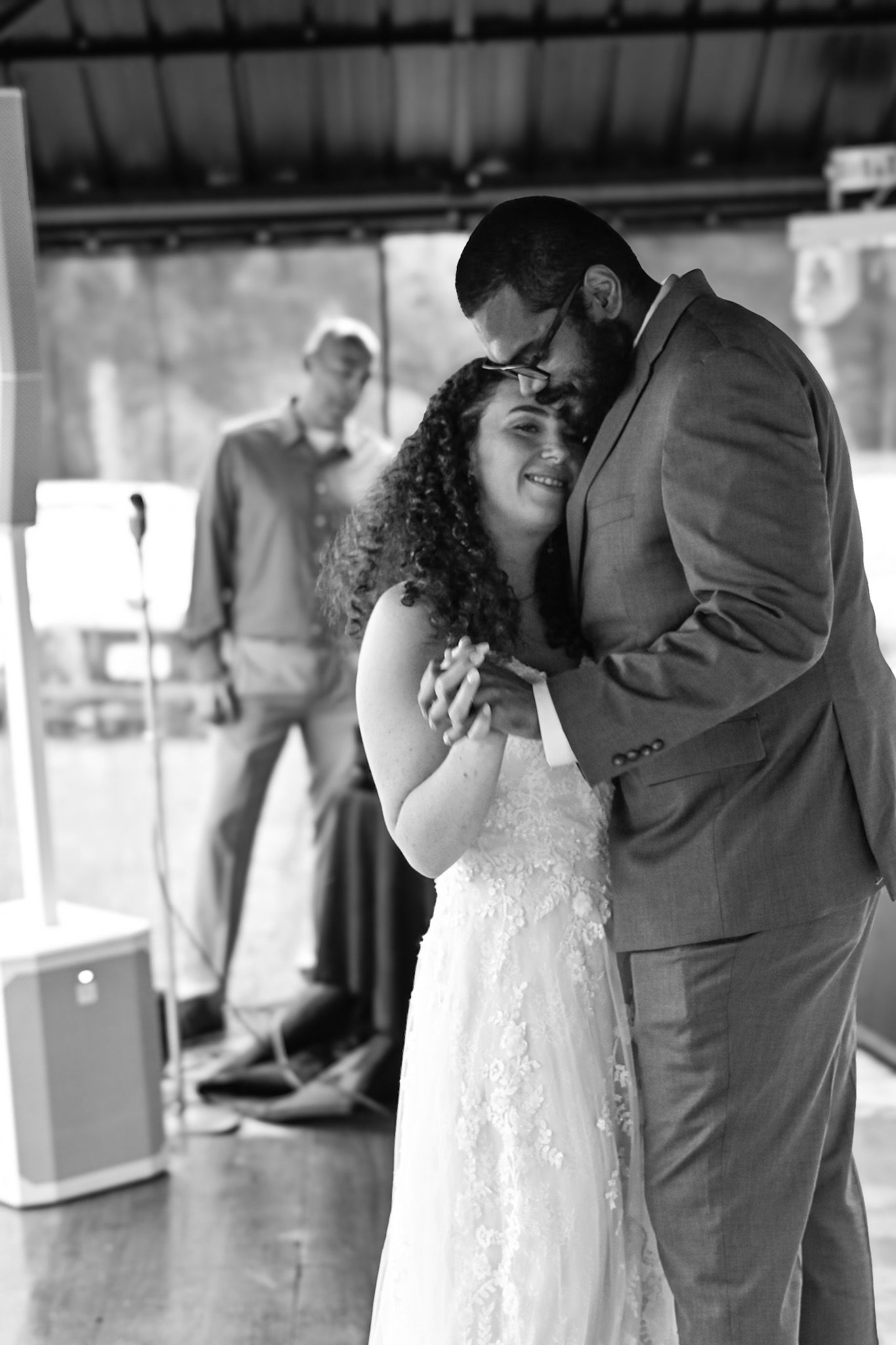 Black and white dance sequence showing couple's romantic moment at wedding reception.