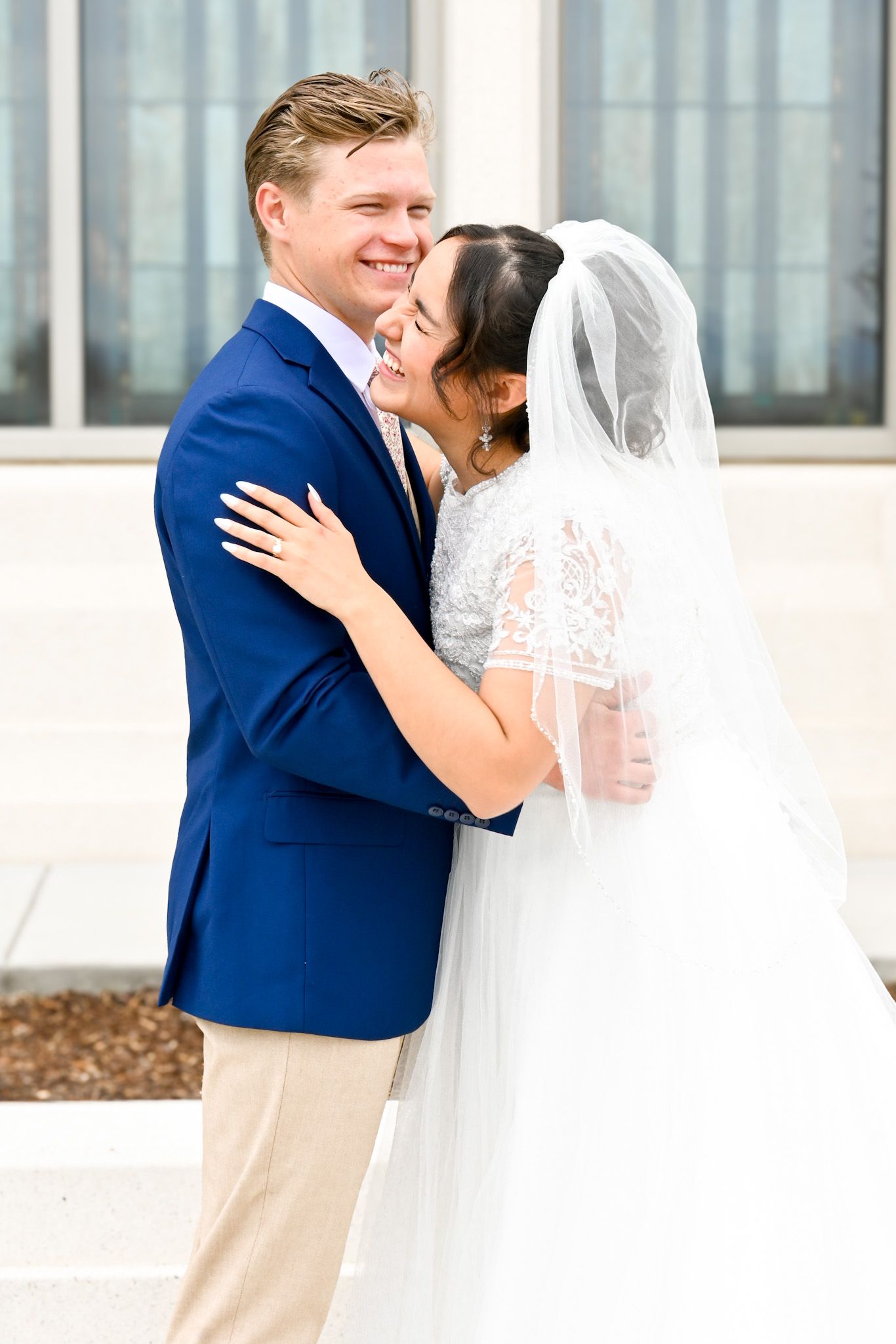 A bride and groom laughing together during bridal photos.