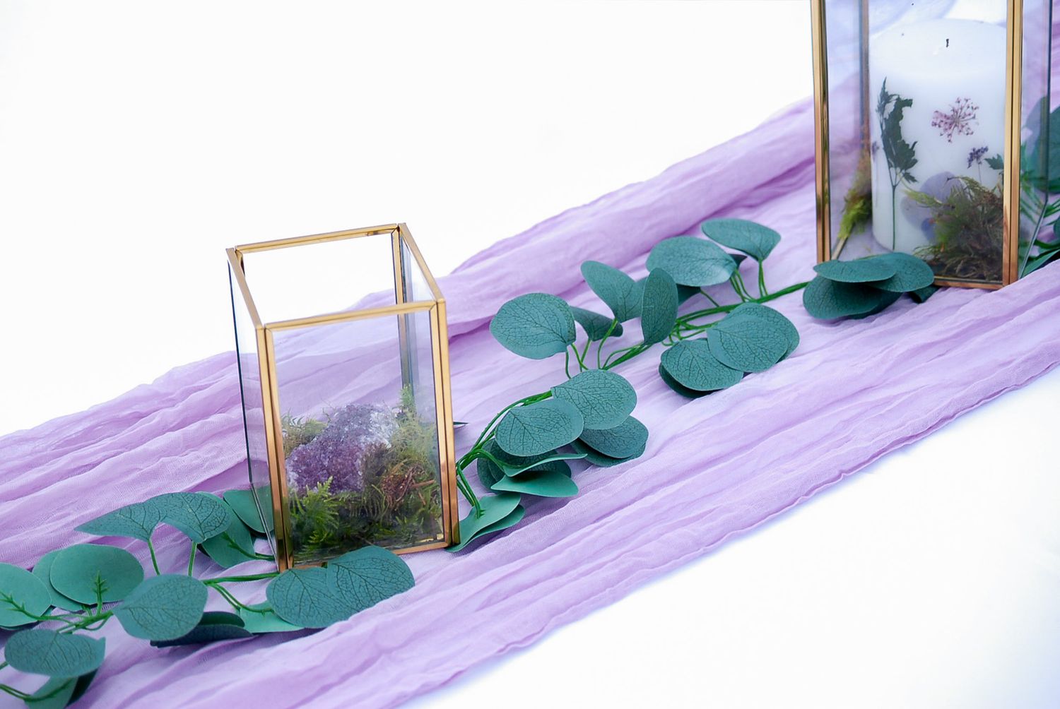 Purple table runner with scattered green leaf decorations and gold accents.