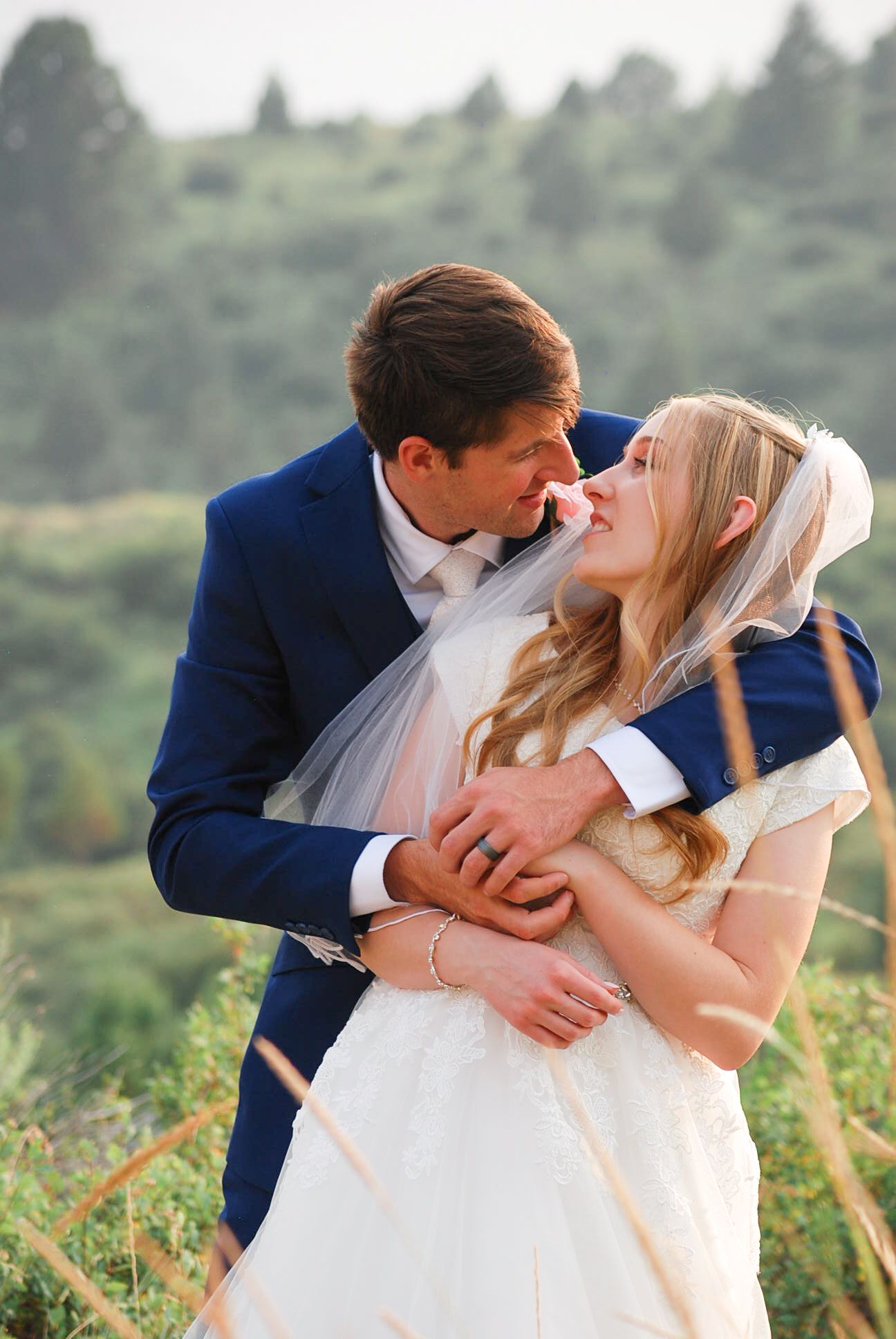Romantic wedding photo sequence showing couple embracing against a natural outdoor backdrop.