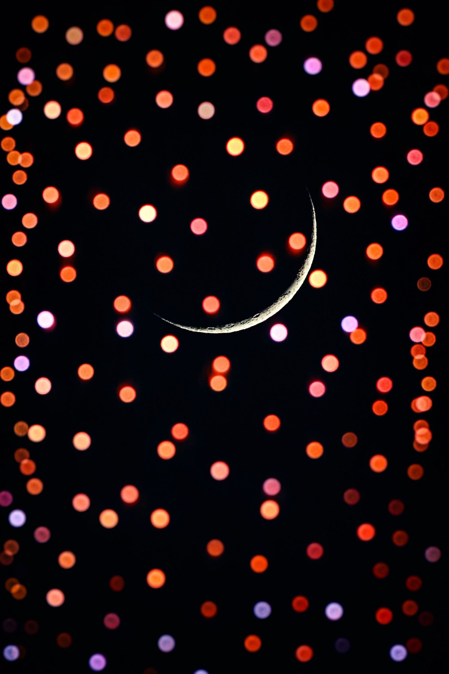 Glowing orange and purple bokeh lights create a magical pattern against a dark background.