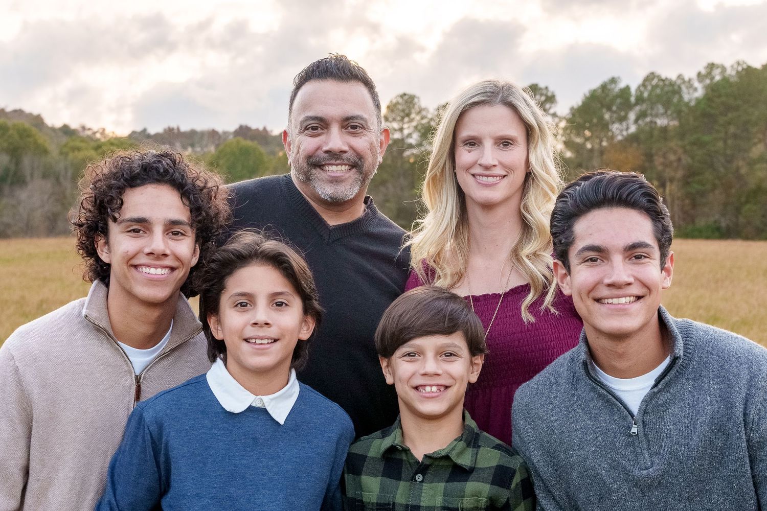 Casual outdoor family portrait series with natural lighting and autumn backdrop.