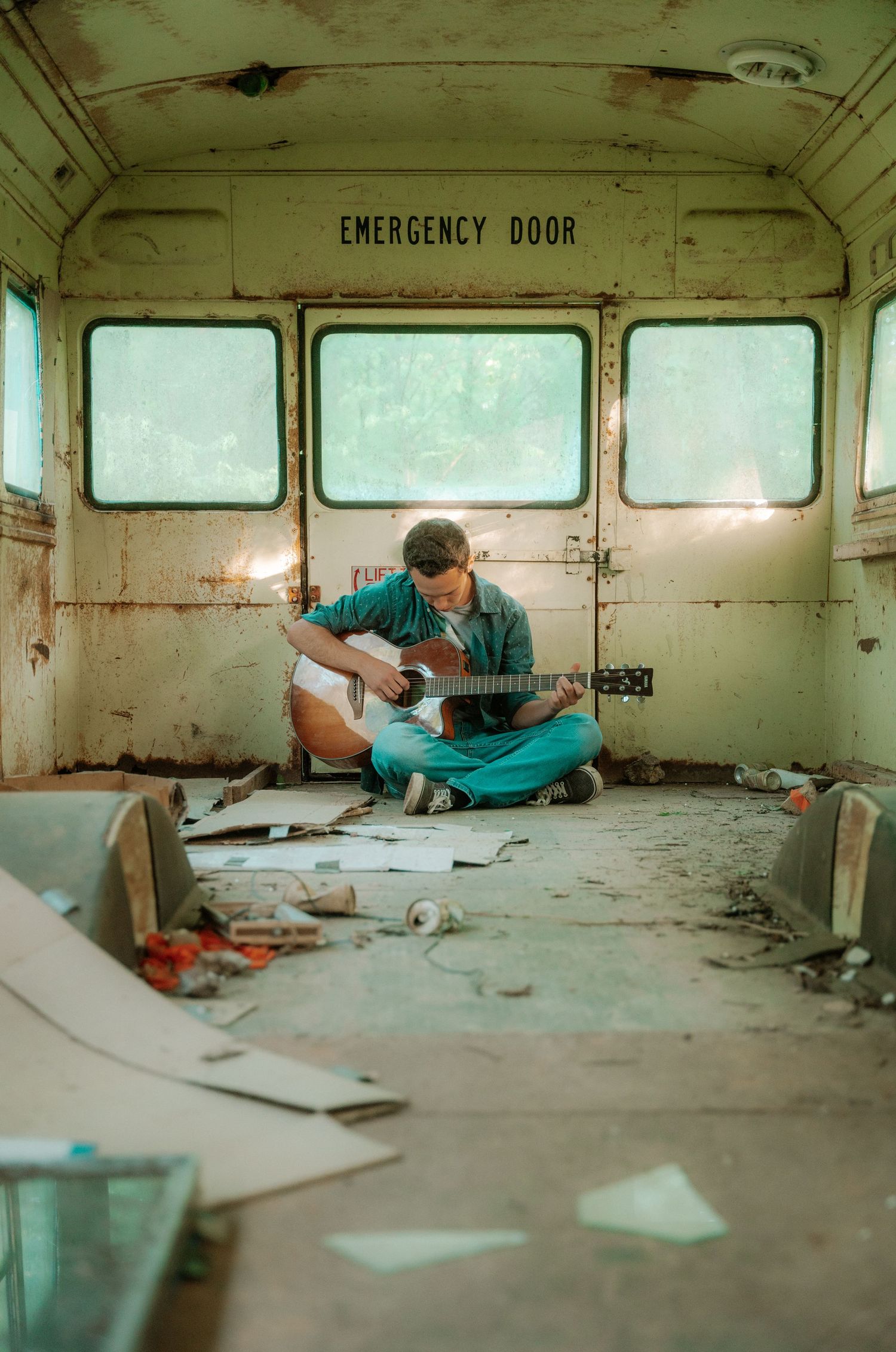 Series of artistic shots inside abandoned bus or train car with emergency door visible.