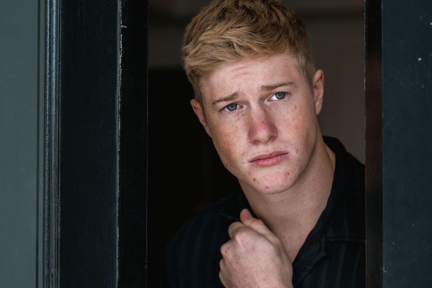 Moody portrait series in dark setting with dramatic lighting.