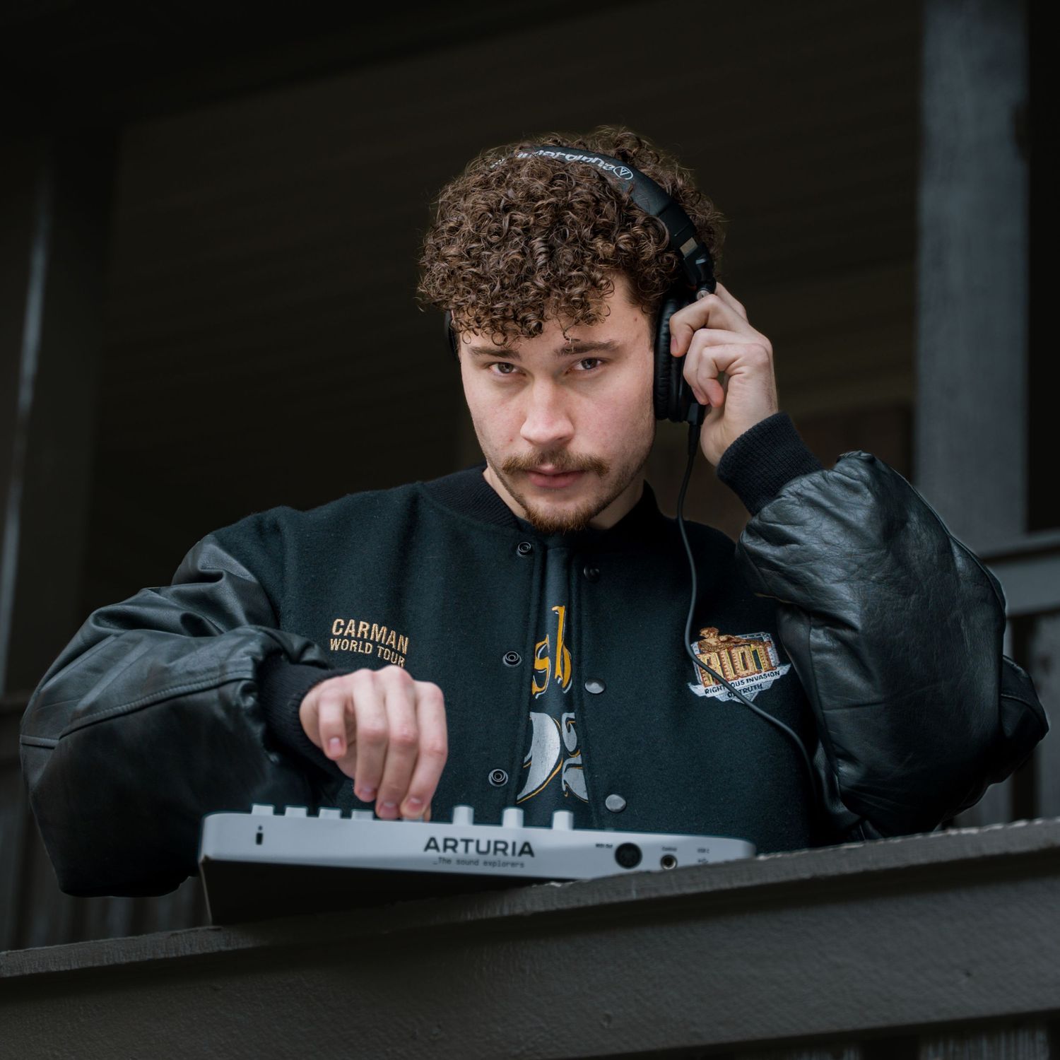Moody studio shots showing someone working with audio equipment in dark lighting.