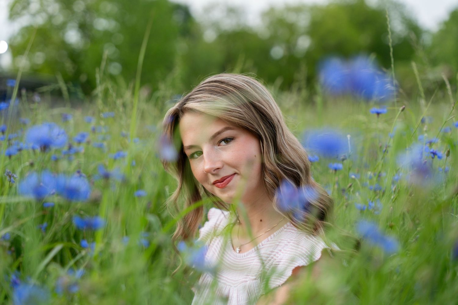 Portrait series in a field of blooming blue wildflowers.