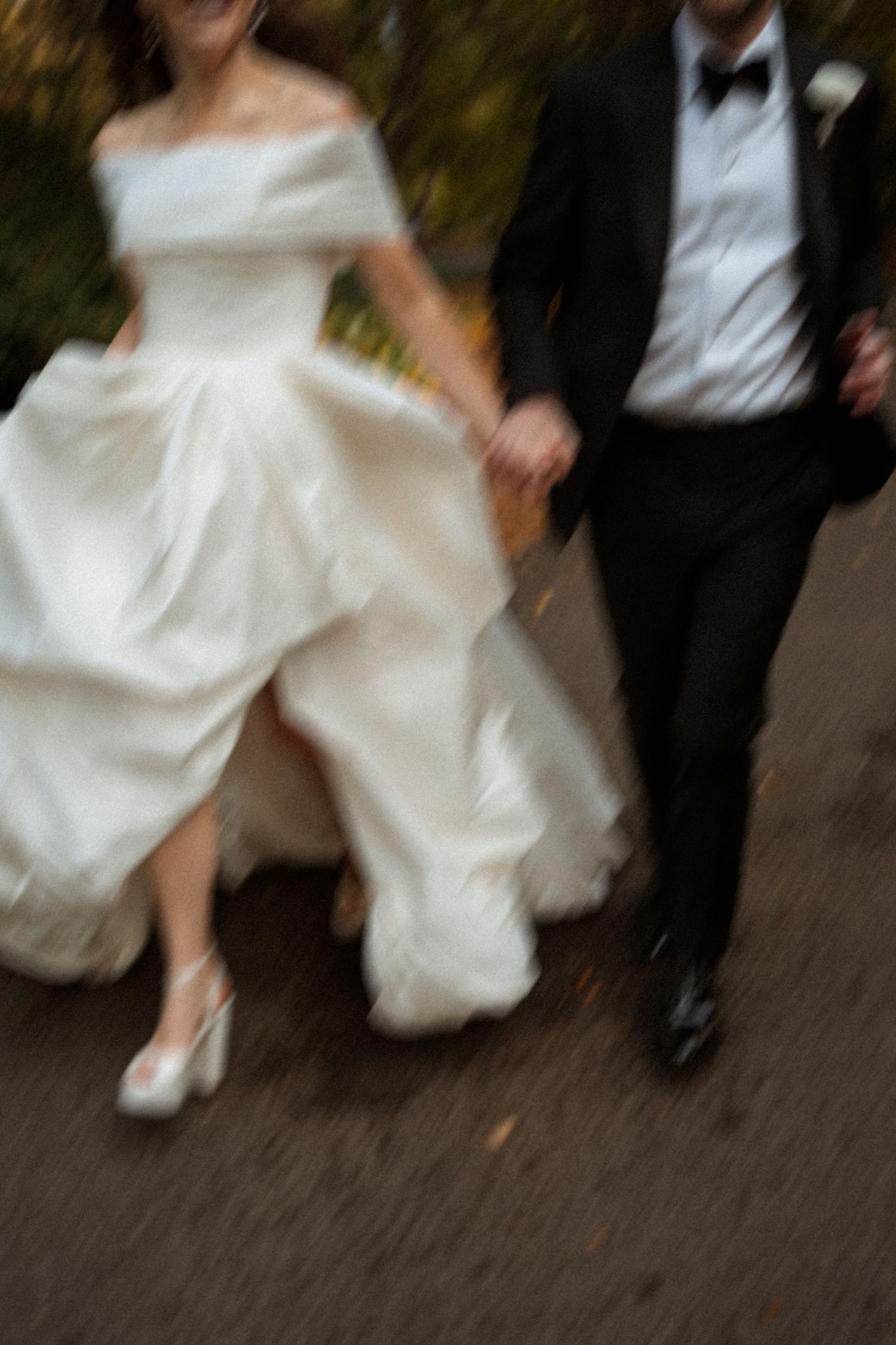 A series of motion shots showing a bride's white wedding dress and groom's black tuxedo feet walking together.