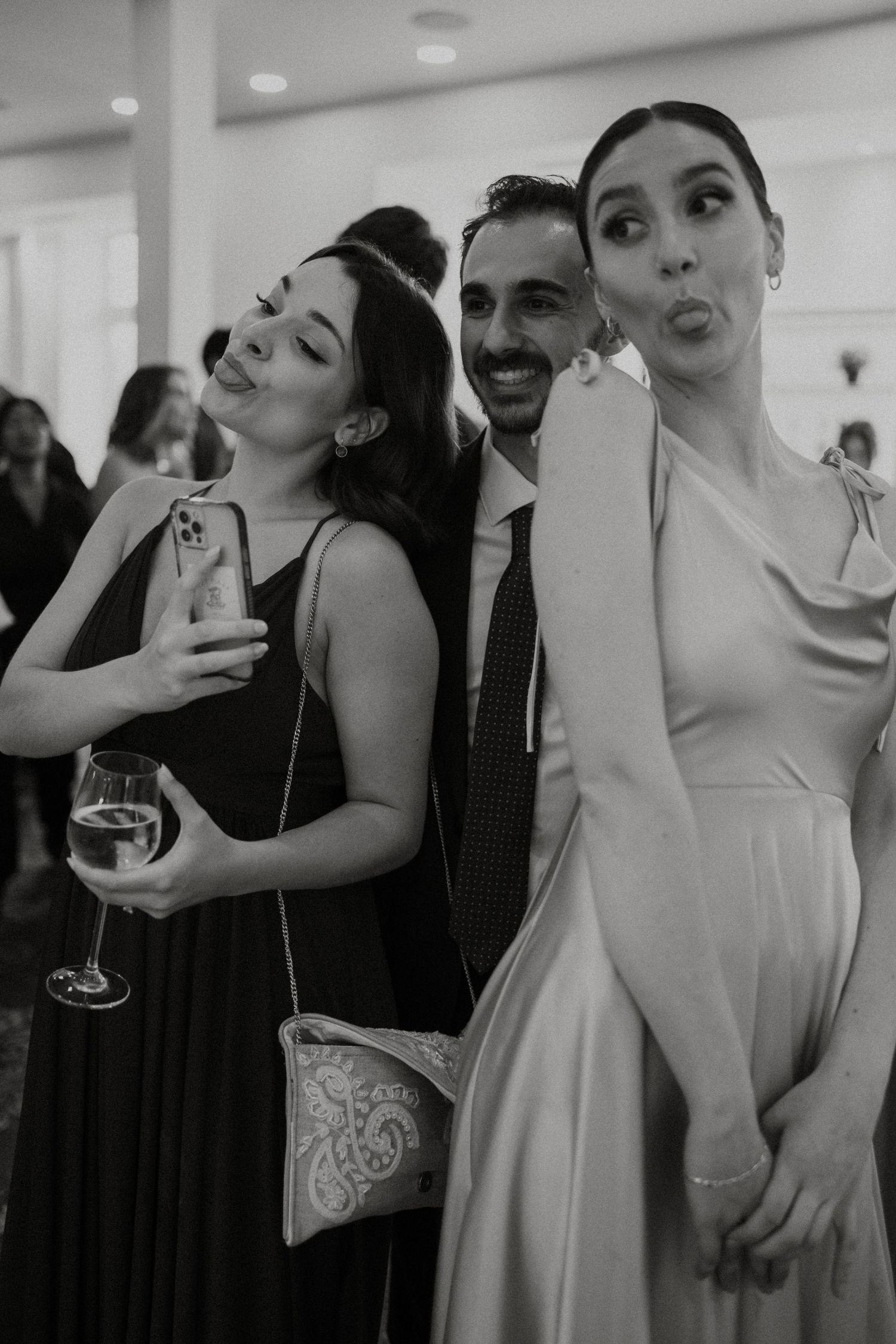 Black and white photo collage showing candid moments of people dancing and laughing at a wedding reception.