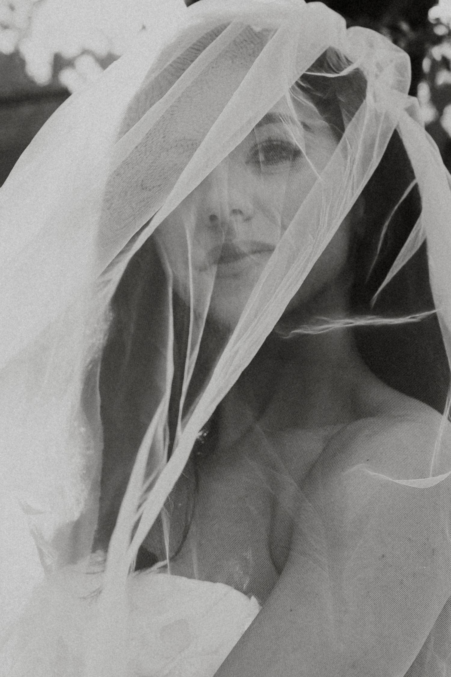 A black and white artistic series showing ethereal flowing white veils creating a dreamy, romantic effect.