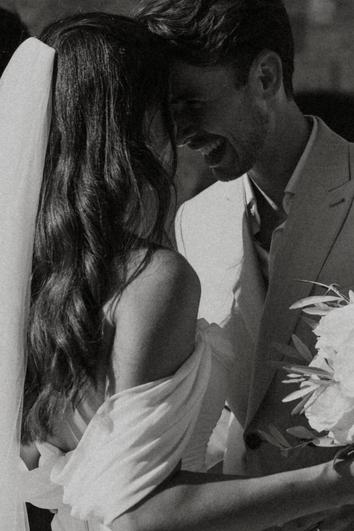 A black and white photo series showing a romantic moment between a couple sharing a kiss.