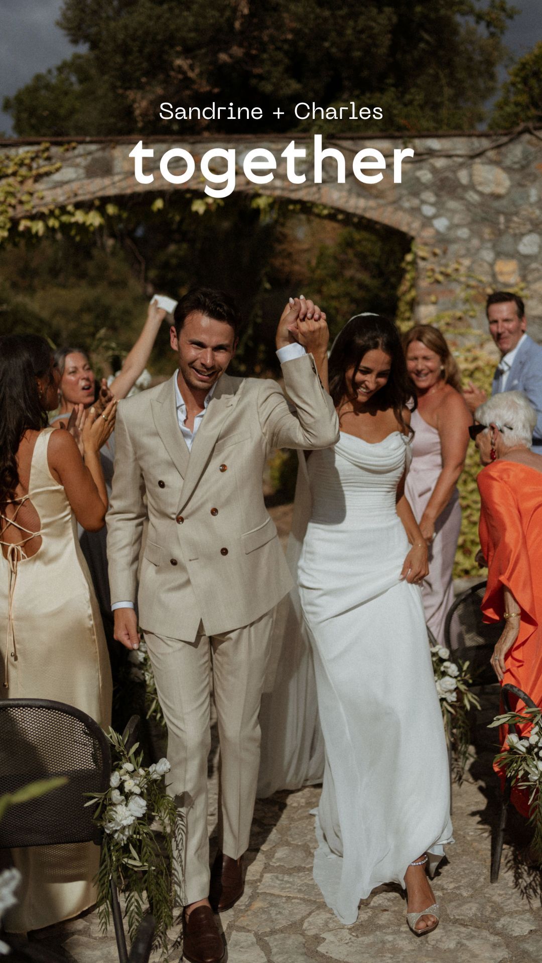 Wedding celebration with guests dancing and celebrating on stone patio.